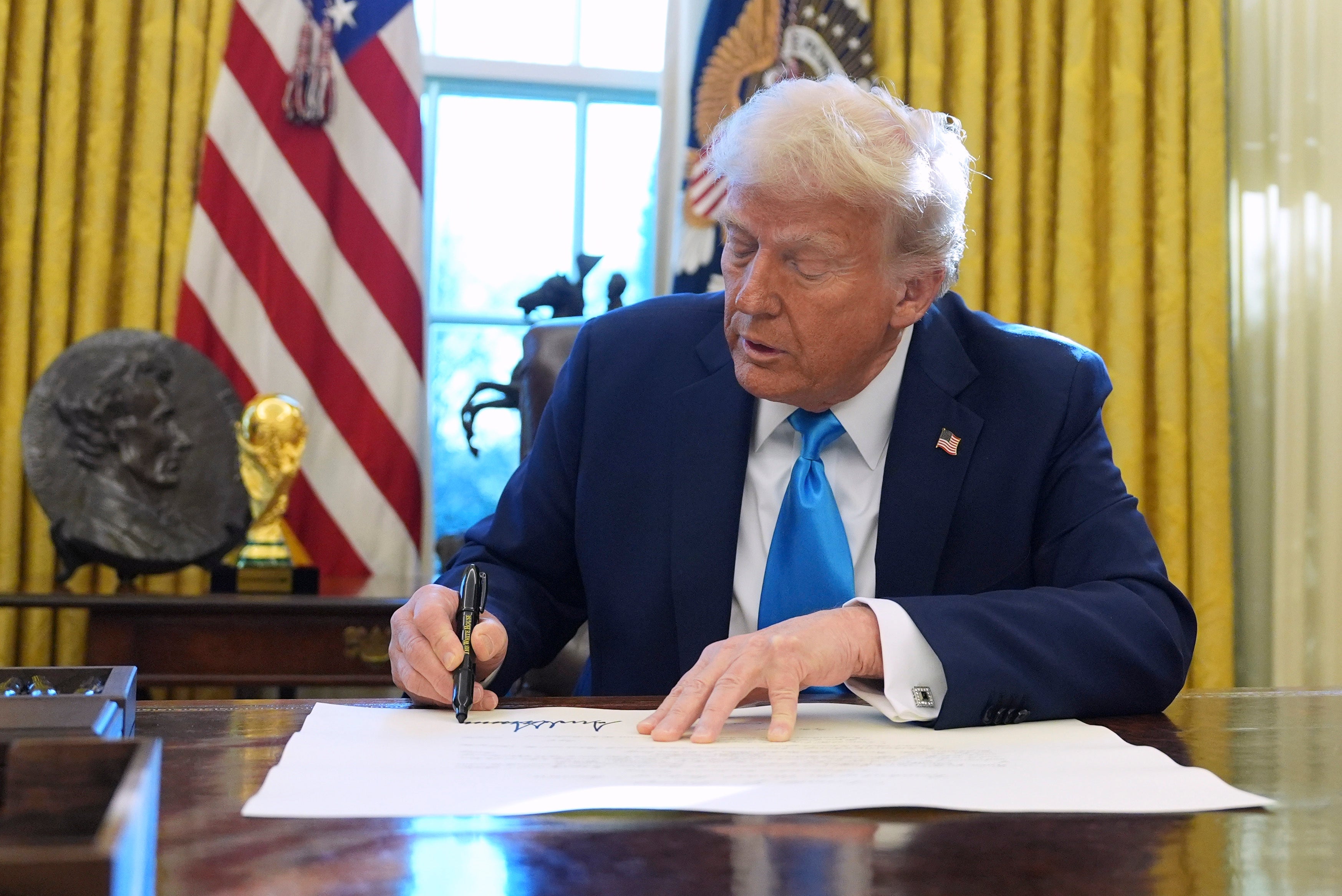 Donald Trump signing an executive order in the Oval Office on Tuesday February 5 2025