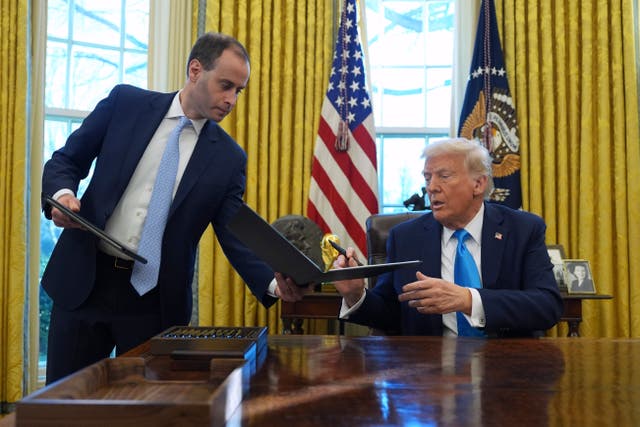 <p> White House Staff Secretary Will Scharf is pictured handing President Trump a document in the Oval Office</p>