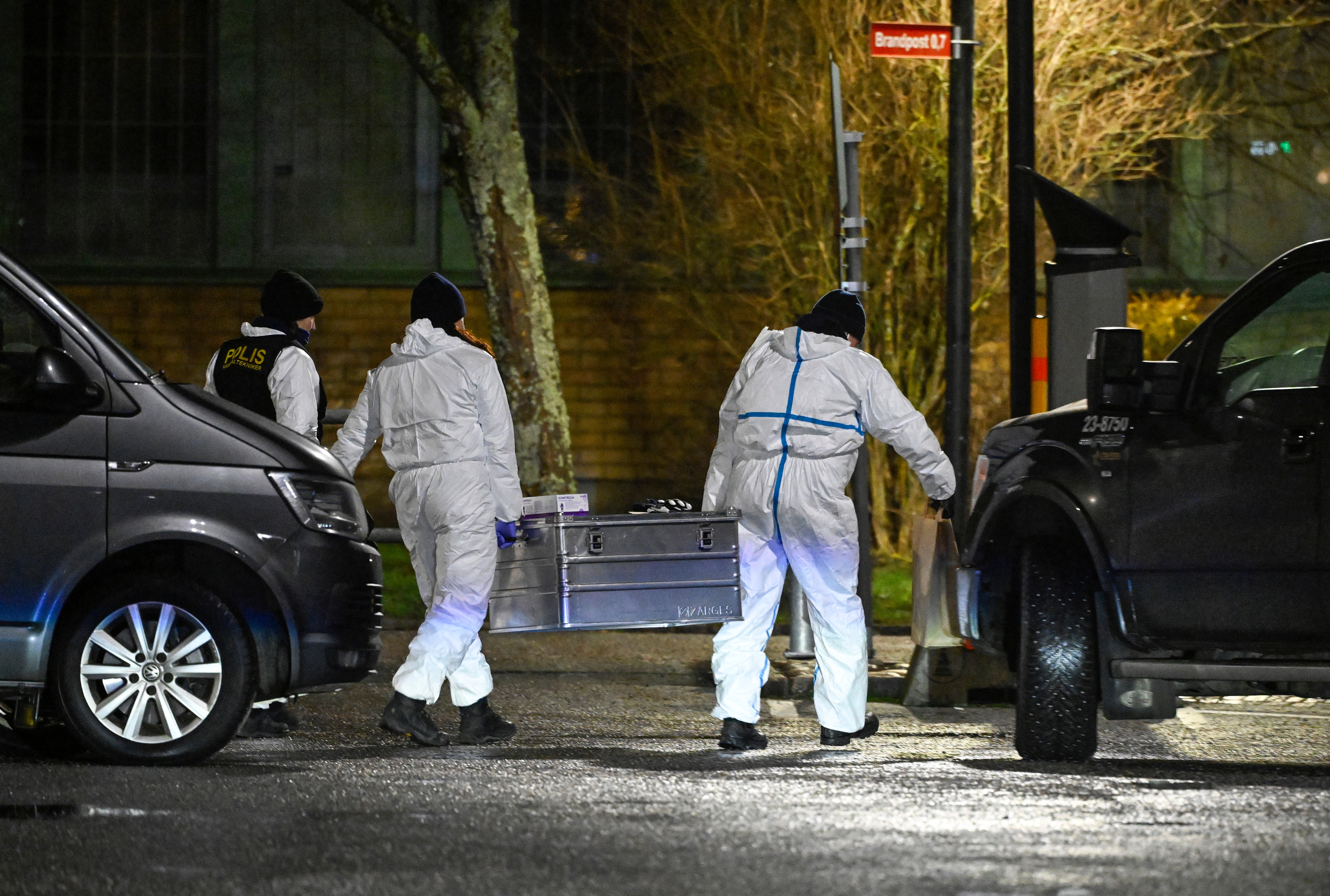 Police technicians work at the scene of a school