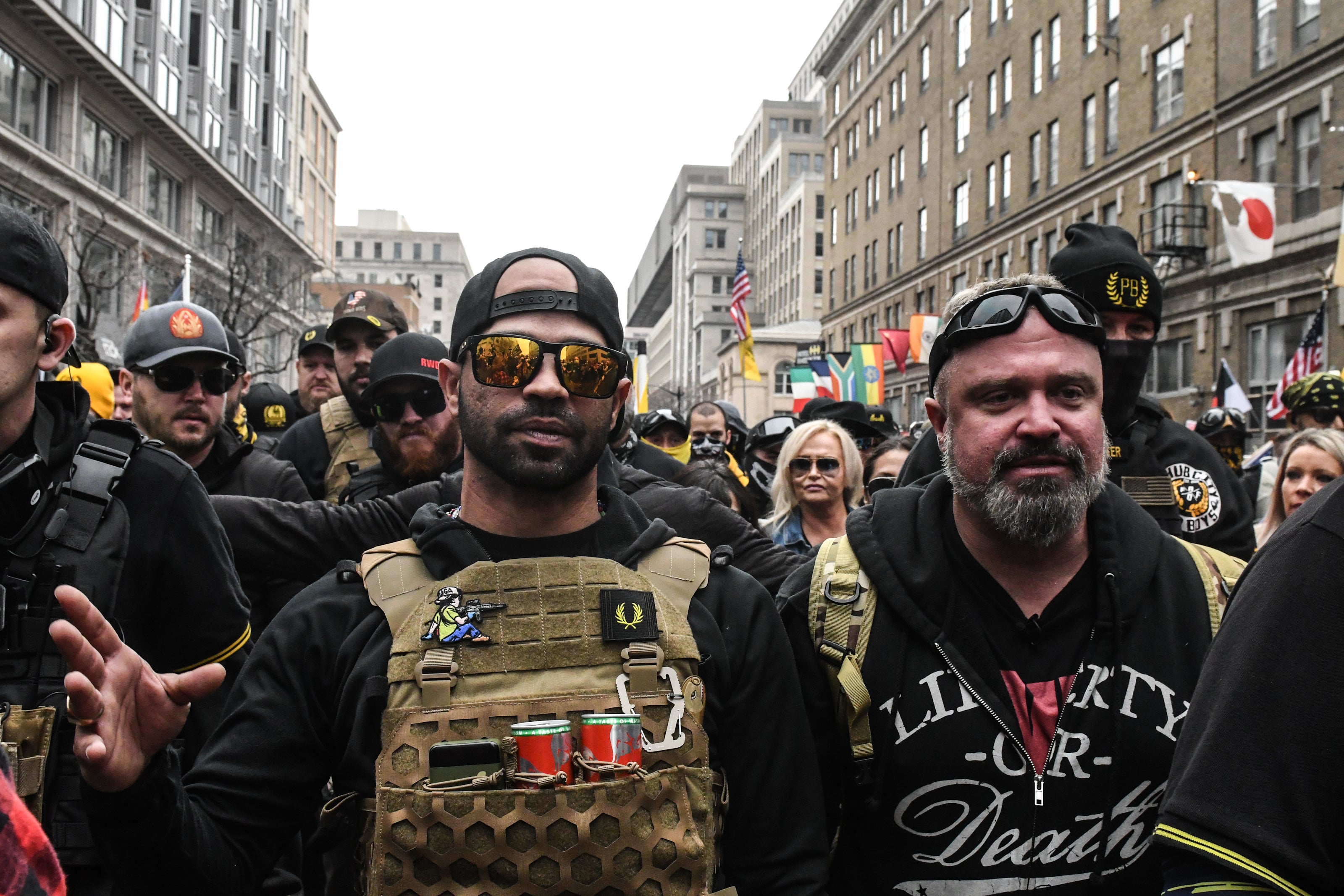 Enrique Tarrio, leader of the Proud Boys (L) and Joe Biggs (R) gather outside of Harry's bar during a protest on December 12, 2020 in Washington, D.C.