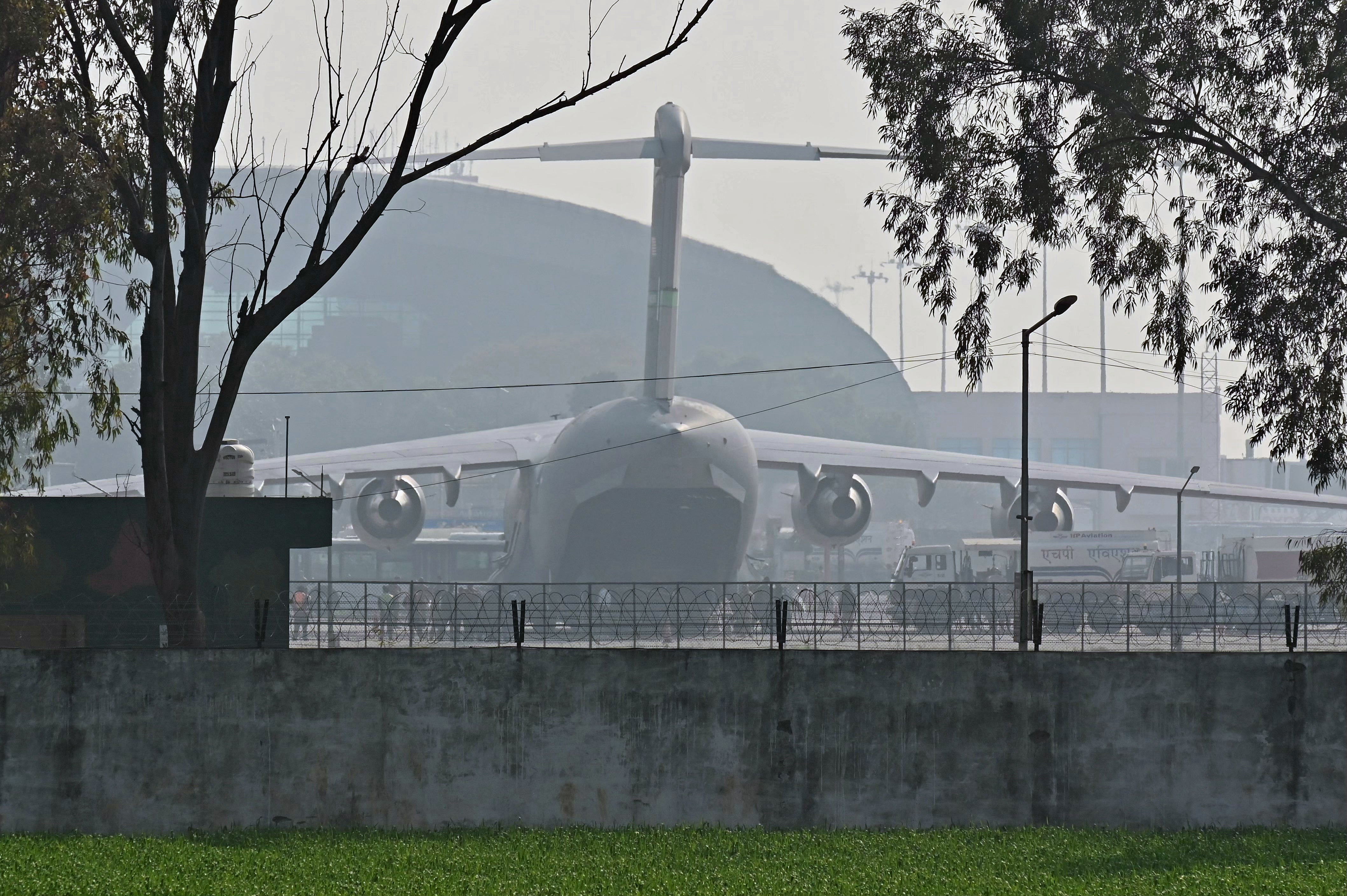 <p>A US Air Force aircraft carrying Indian migrants deported from the US, stands on the tarmac after landing at the Guru Ram Das Jee International Airport in Amritsar</p>