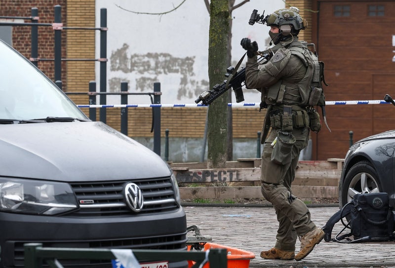 Belgian police hunt for masked gunmen after shooting outside Brussels metro