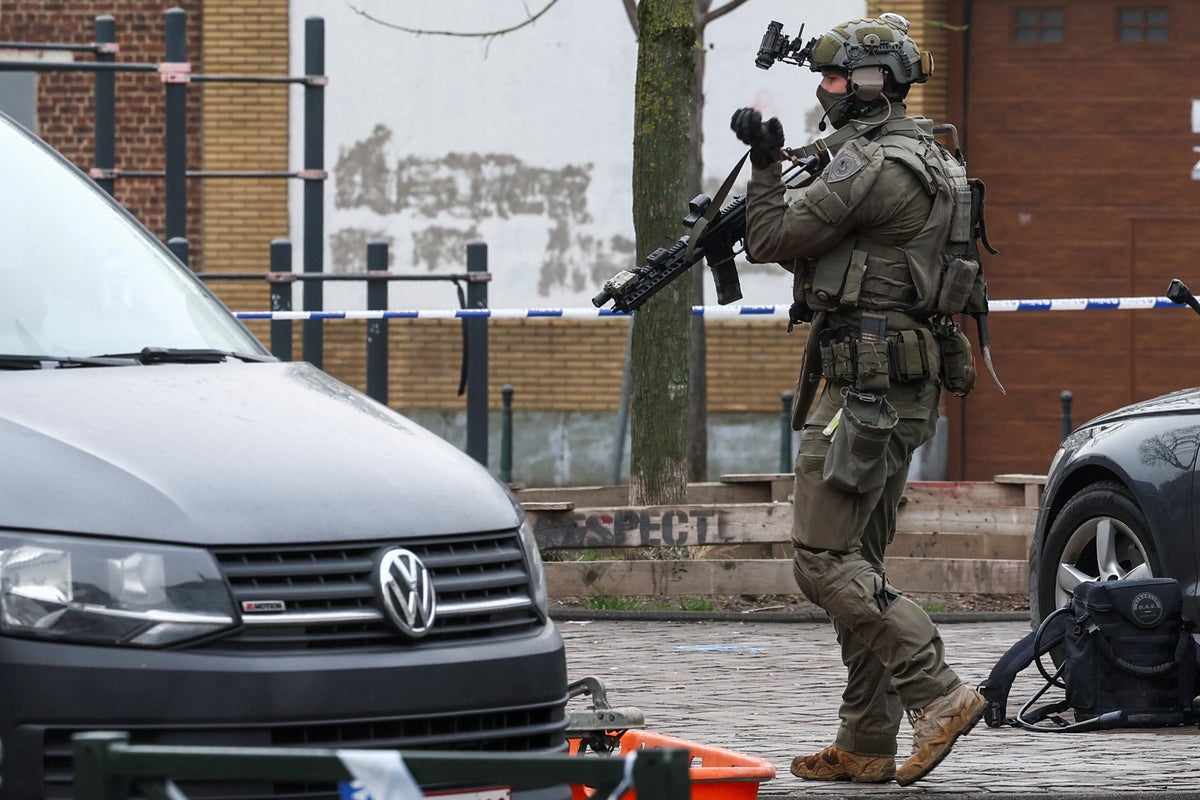 Belgian police hunt for masked gunmen after shooting outside Brussels metro
