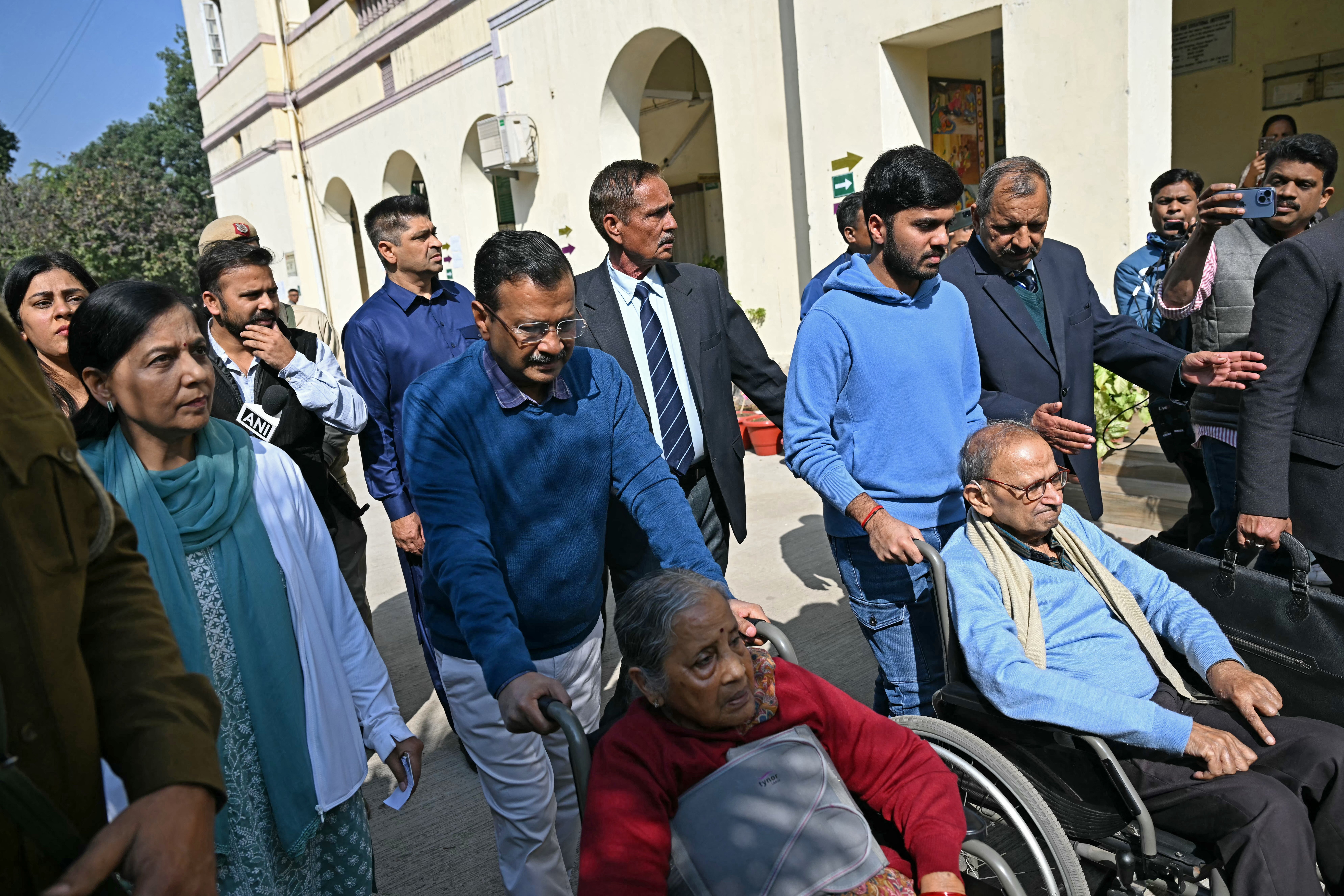 <p>Delhi's former chief minister and Aam Aadmi Party leader Arvind Kejriwal, centre, leaves with his parents after casting their votes at a polling station</p>