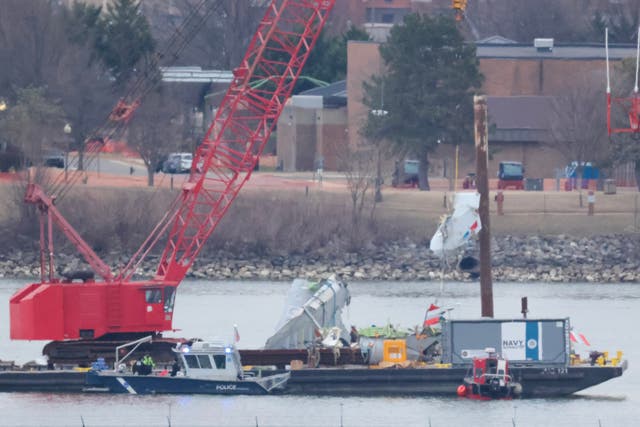 <p>A crane pulls up pieces of debris during recovery efforts after the American Airlines crash, on February 05, 2025 in Arlington, Virginia</p>