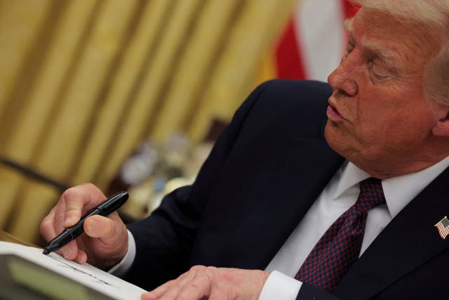 <p>President Donald Trump signs an executive order. There are several parallels between Project 2025 and the many orders he has signed since taking office</p>