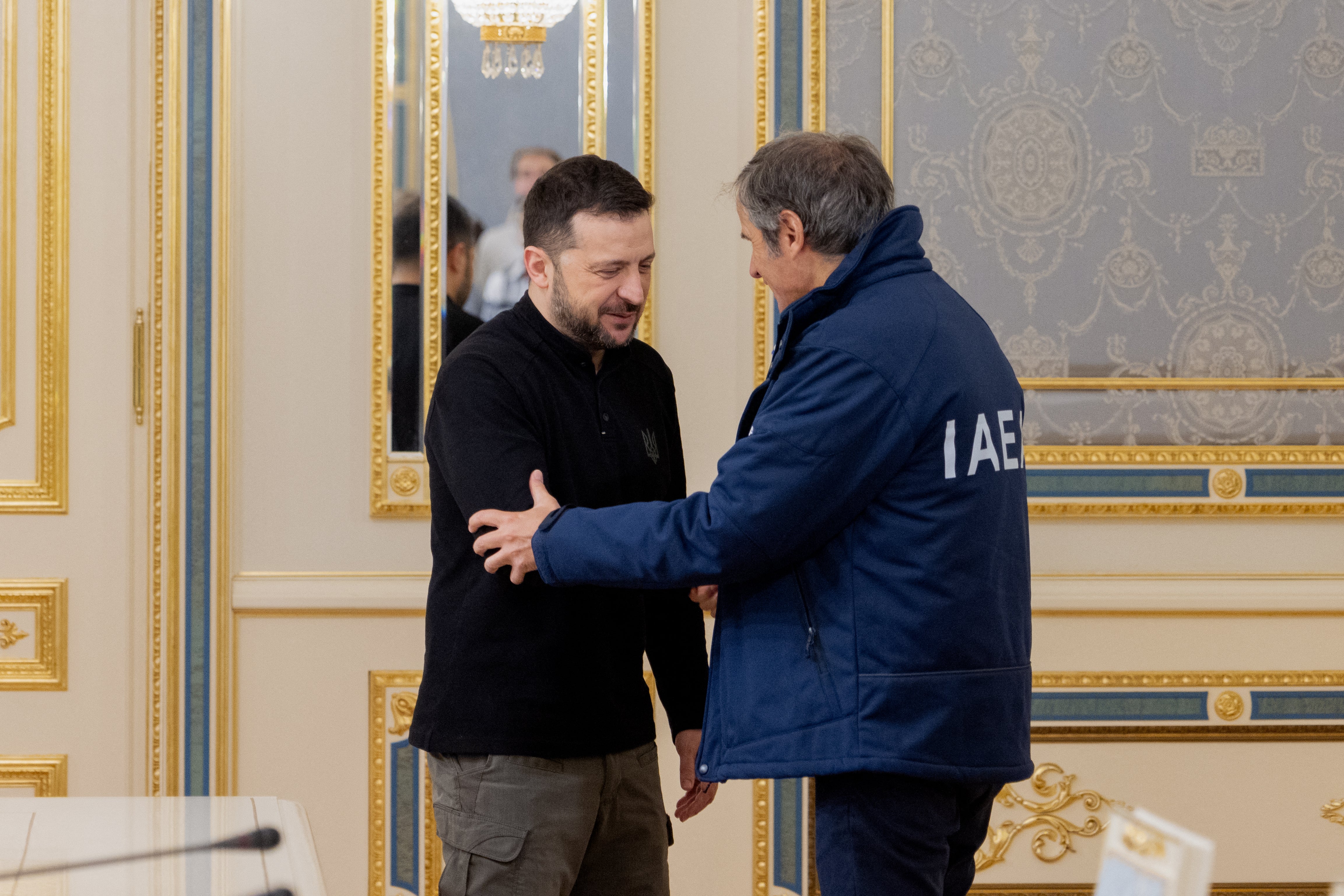 Volodymyr Zelensky and International Atomic Energy Agency (IAEA) director general Rafael Mariano Grossi shake hands after their meeting in Kyiv