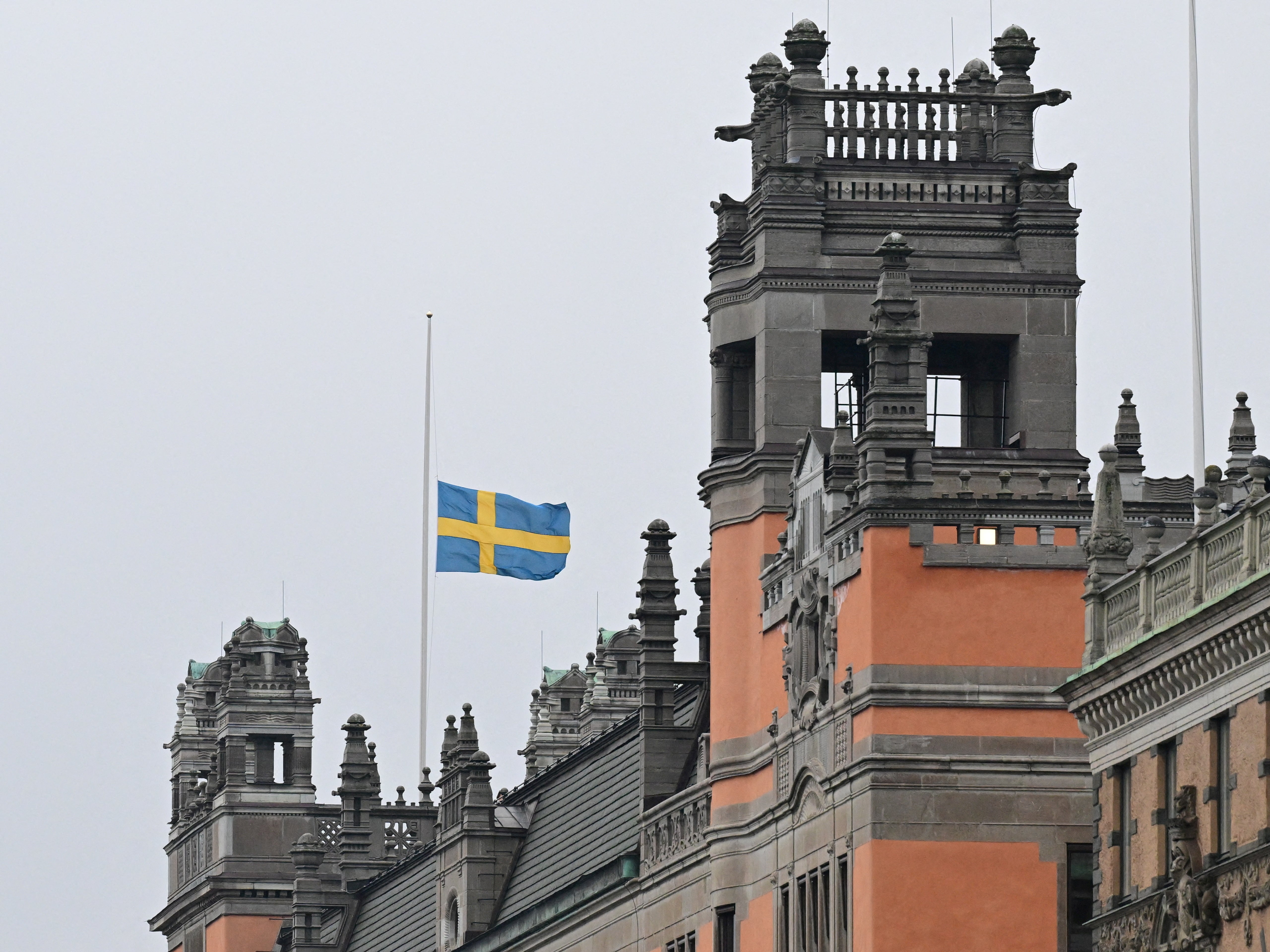 Swedish flag flies at half-mast, following yesterday's school shooting in Orebro, on the government offices (Rosenbad) in Stockholm