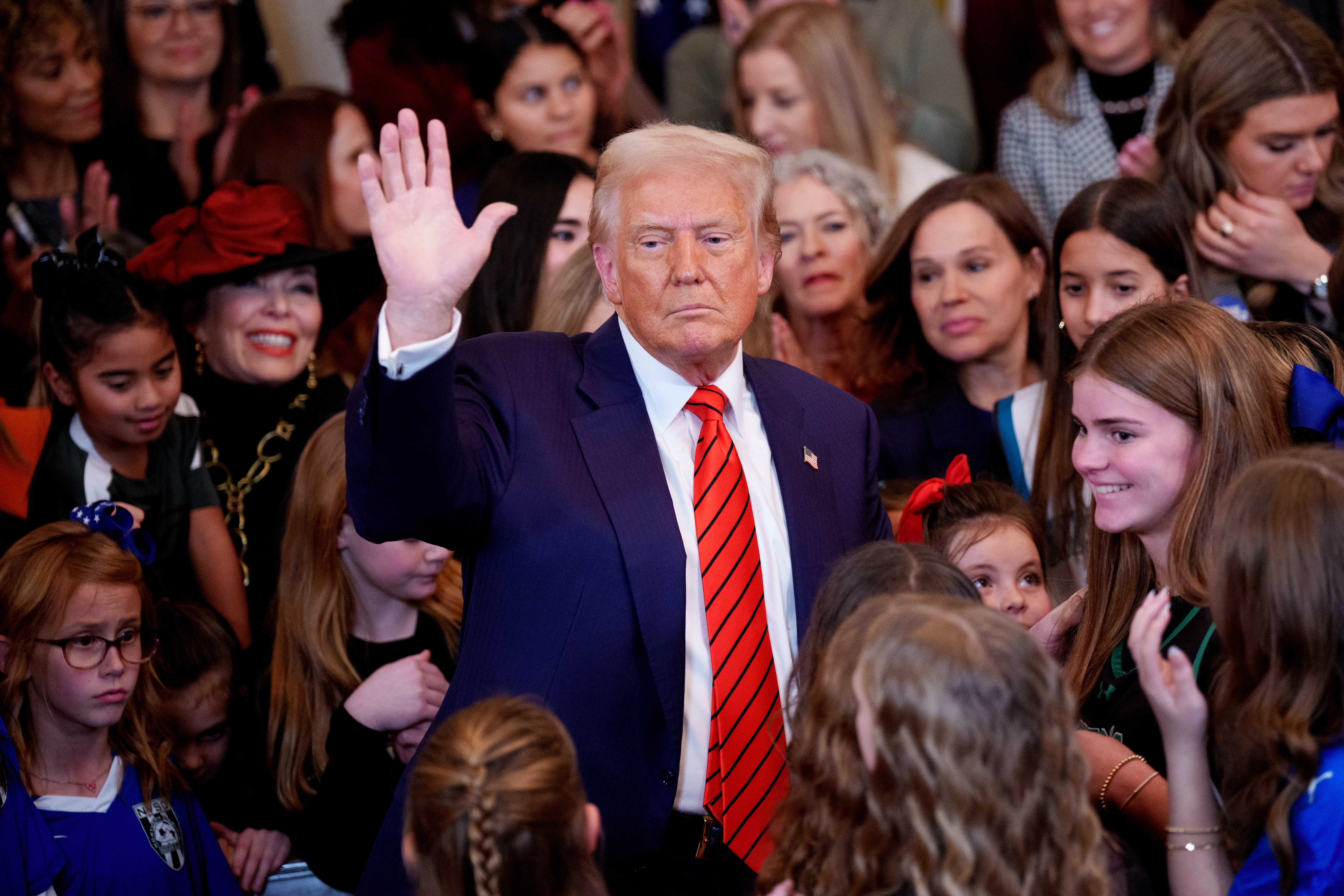 Donald Trump surrounded by women and girls as he announced the trans order