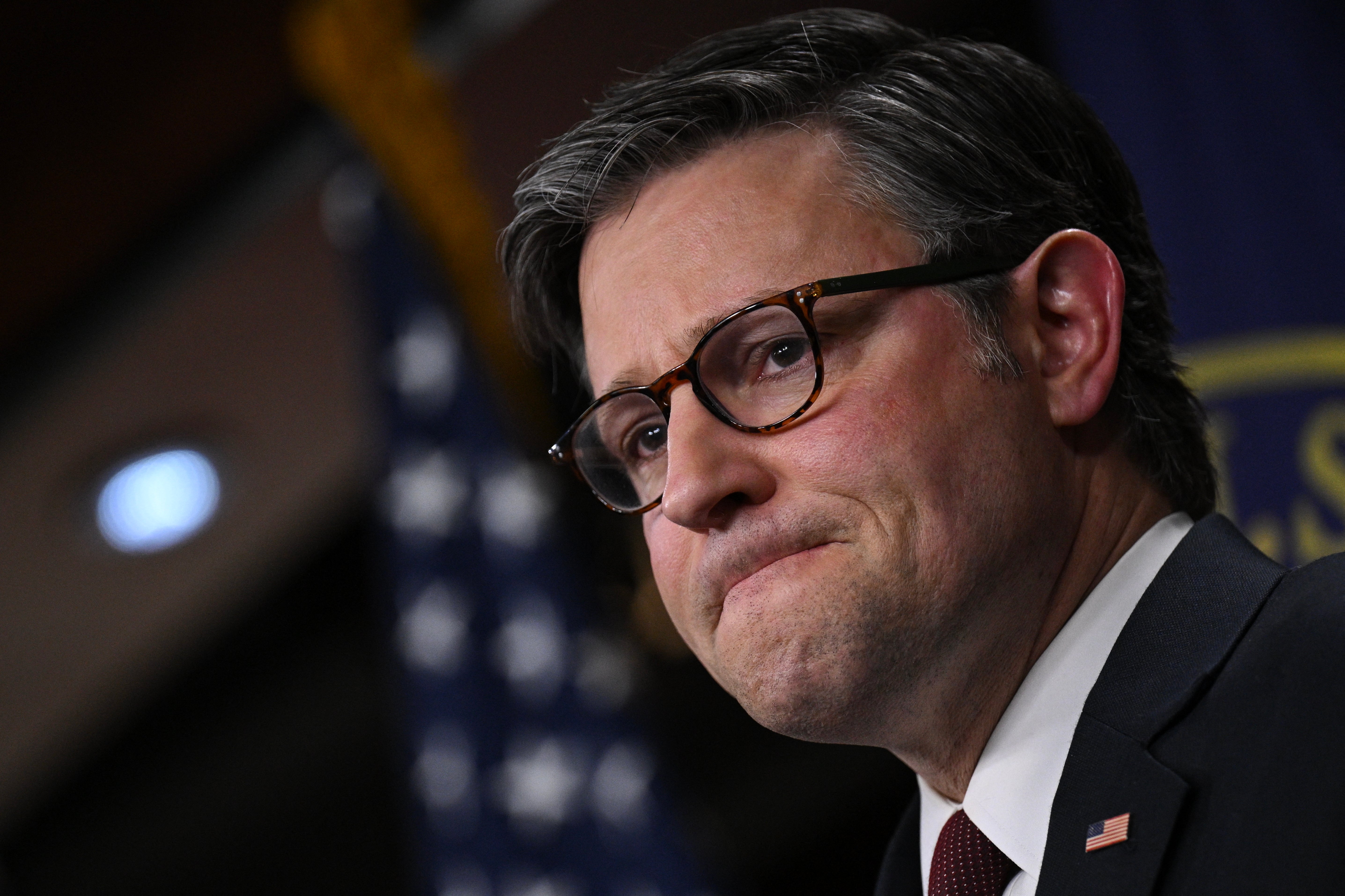 Mike Johnson looks on during a grilling at news conference on Capitol Hill in Washington, DC on Wednesday