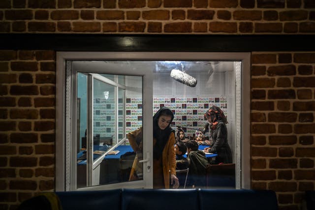 <p>Teachers and students attending a class on-air at Radio Begum in Kabul in 2021</p>