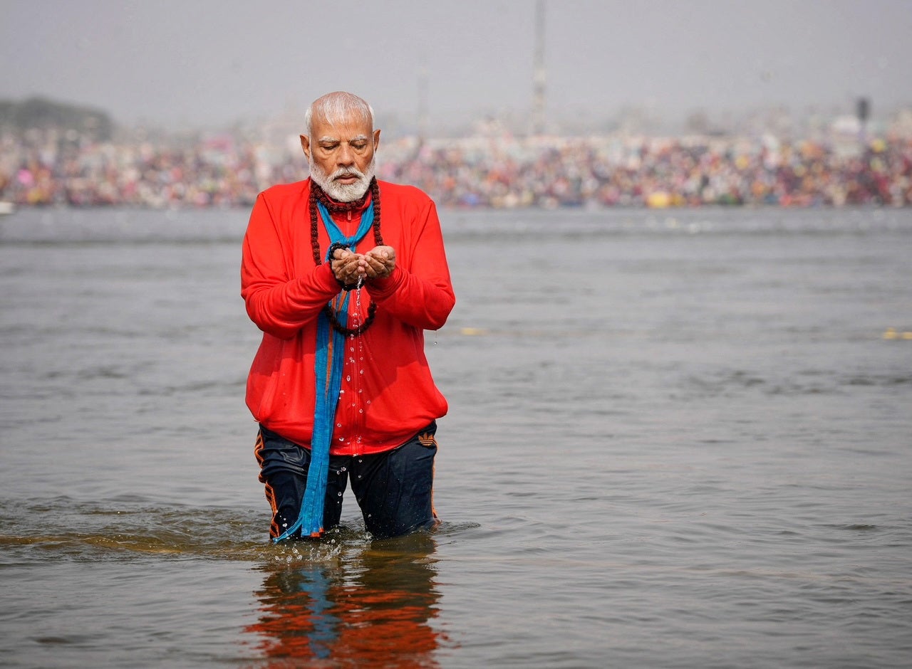 India's prime minister Narendra Modi prays as he takes a holy dip during the ongoing Maha Kumbh Mela