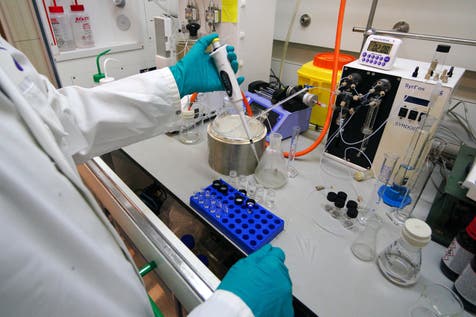 <p>A worker at the AstraZeneca vaccine plant in Macclesfield</p>