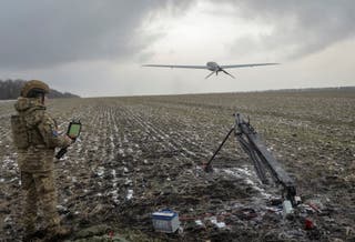 A serviceman of the 25th Separate Airborne Brigade of the Armed Forces of Ukraine launches a Shark reconnaissance drone near the frontline town of Pokrovsk in Donetsk region, Ukraine