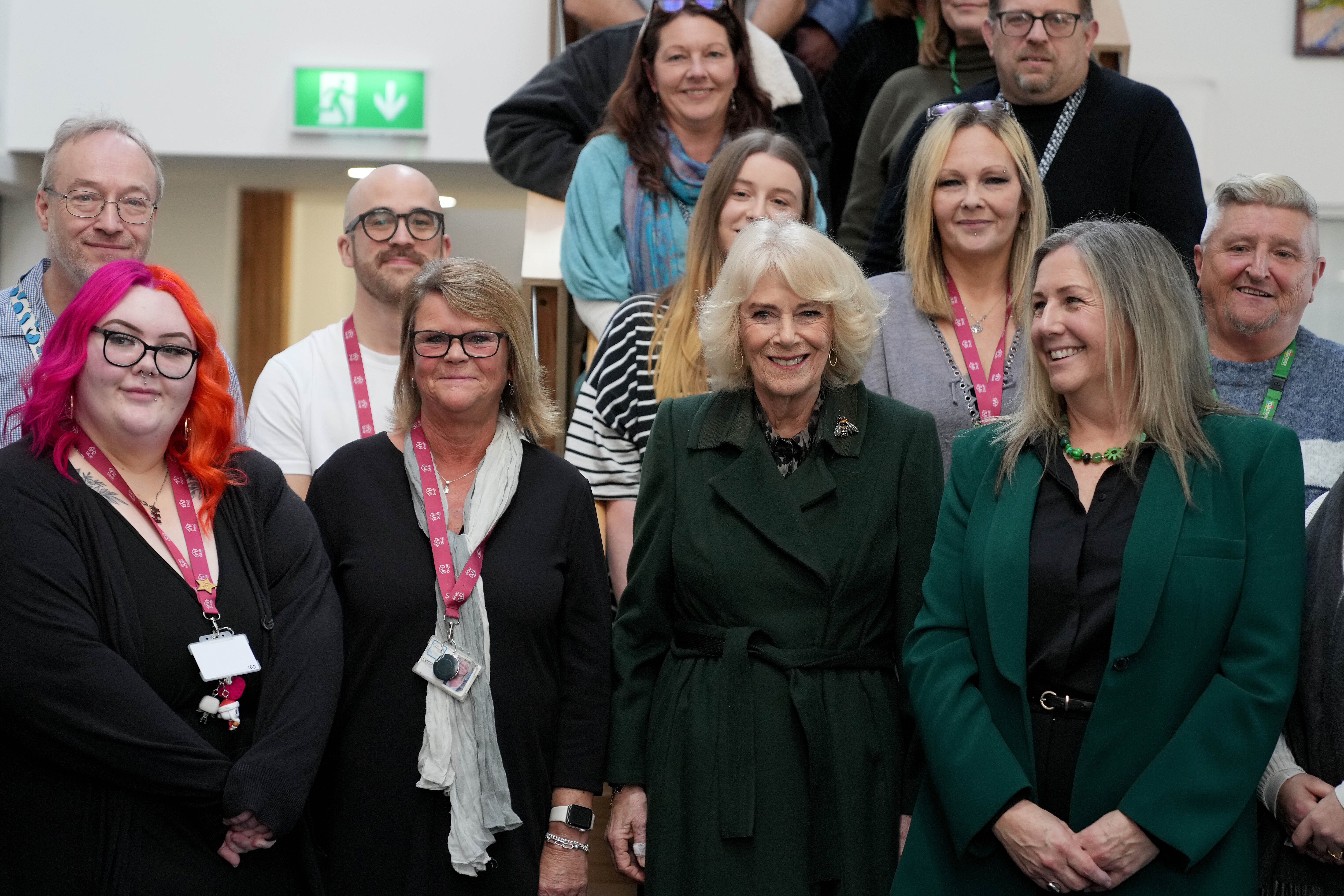 Queen Camilla poses with staff members during a visit to CoLab Exeter (Alastair Grant/PA)