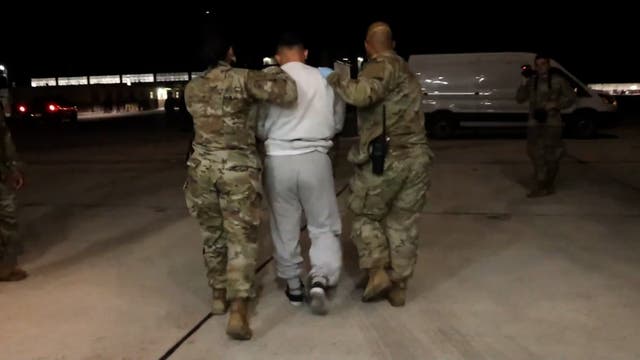 <p>The Trump administration has sent flights of ‘criminal’ migrants to the notorious detention center and military base at Guantánamo Bay. New video from the government shows people being escorted on the base</p>