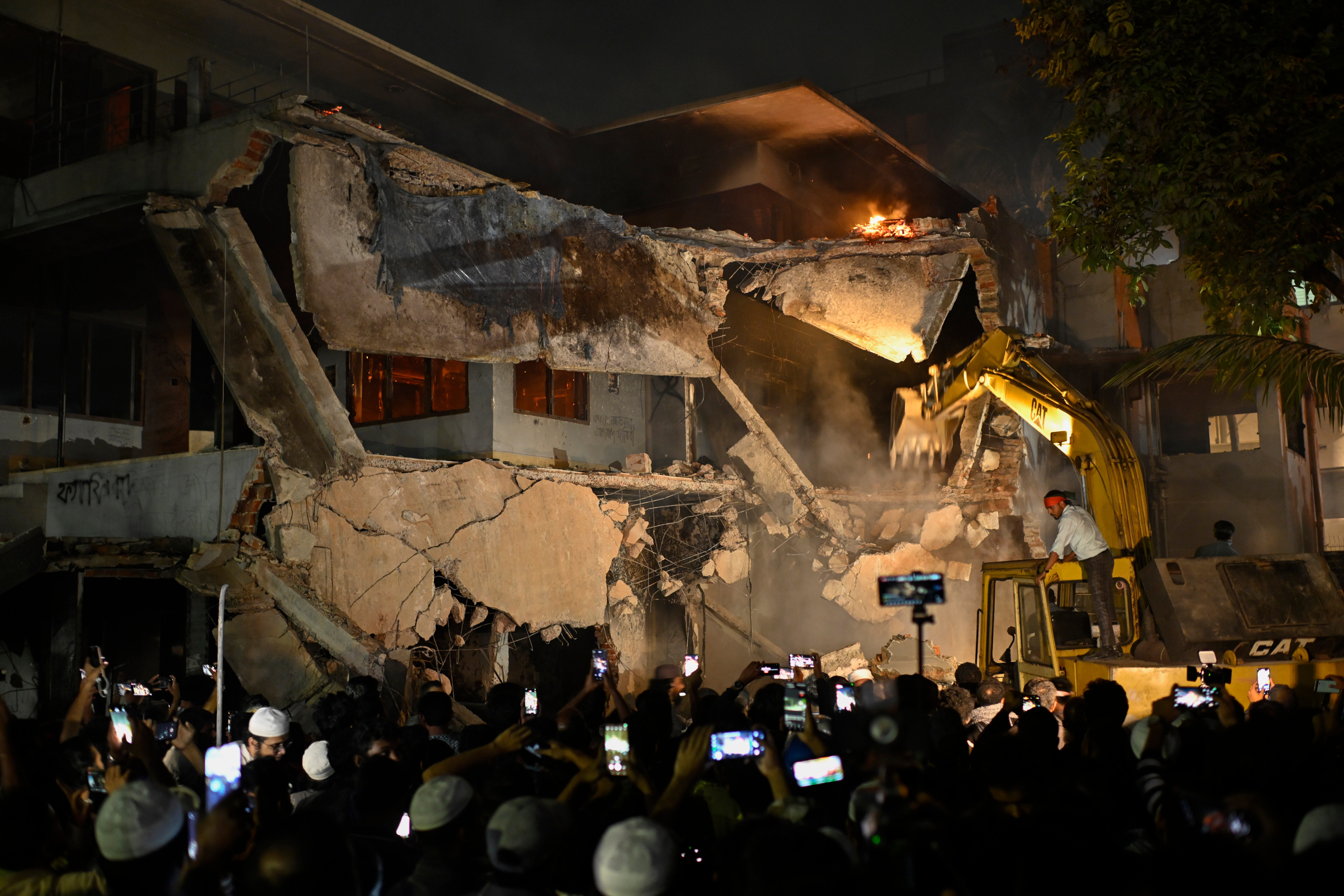 Protesters use heavy machinery to demolish the residence of Sheikh Mujibur Rahman, Bangladesh's former leader and the father of the country's ousted Prime Minister Sheikh Hasina, at Dhanmondi in Dhaka