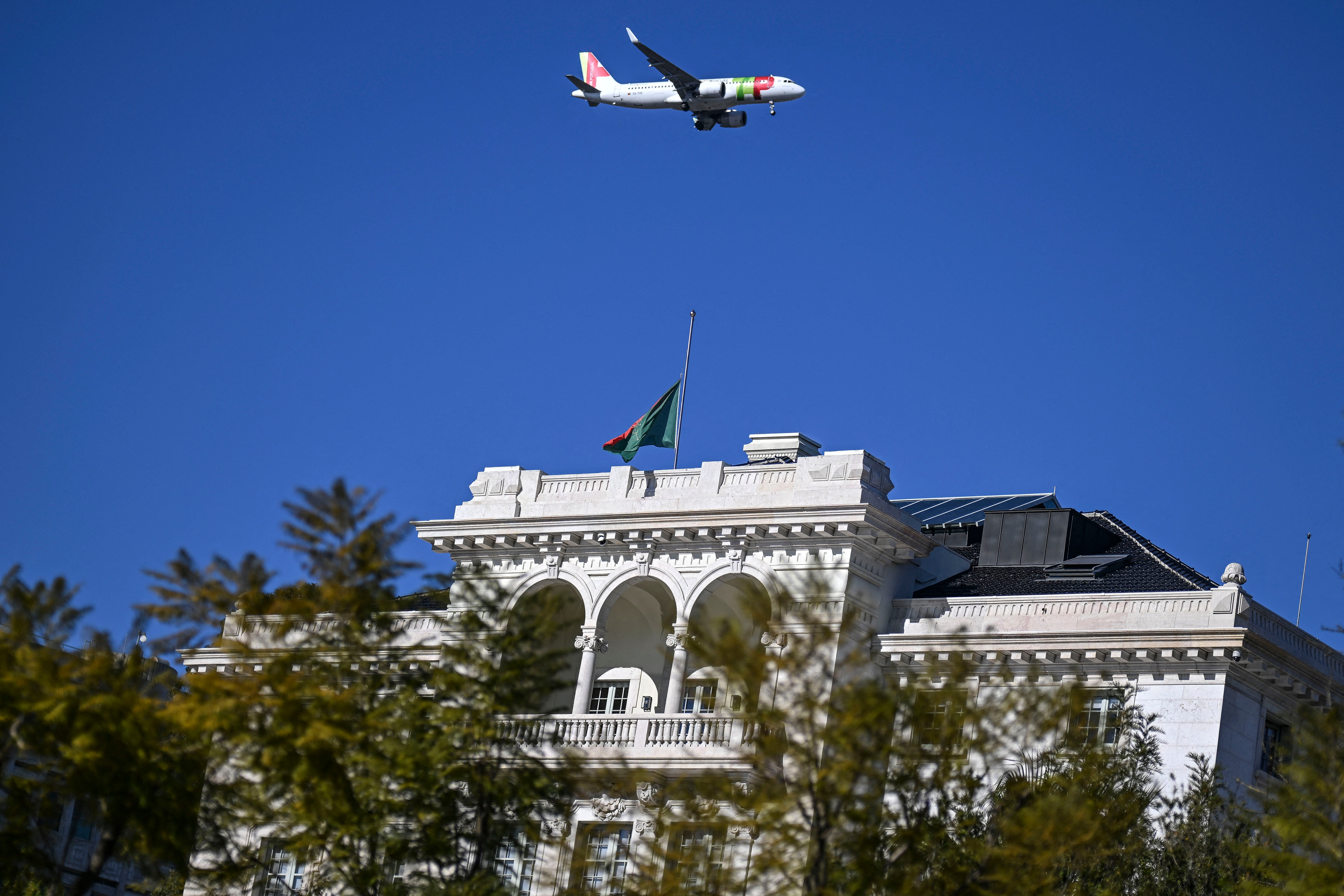 A TAP Portuguese Airline aircraft flies over the Aga Khan Foundation headquarters in Lisbon on 5 February 2025, with the flag at half mast, following the death of Prince Karim al-Hussaini Aga Khan IV, Imam of the Ismaili Muslims in Lisbon. The Aga Khan, imam of the Ismaili Muslims and head of a major development aid foundation, died in Lisbon at the age of 88