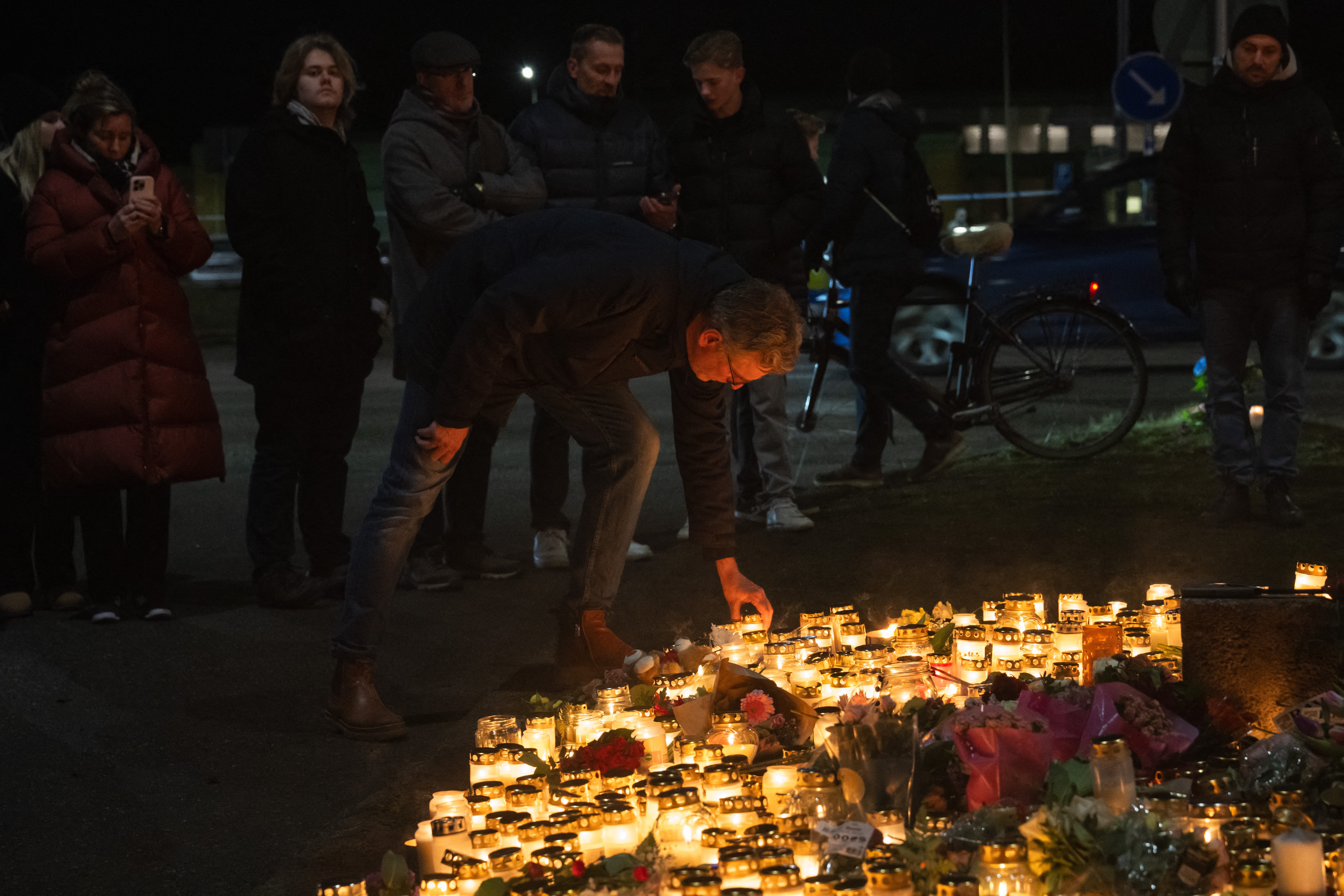 People gather at a makeshift vigil near the adult education center Campus Risbergska school in Orebro