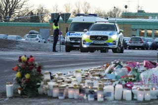 Security guards near the interim monument at the scene of the shooting