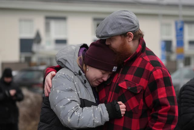 <p>Dozens have gathered at a makeshift memorial near the scene of the massacre</p>