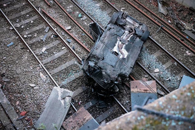 <p>A car crashed onto the train tracks in Greater Manchester</p>
