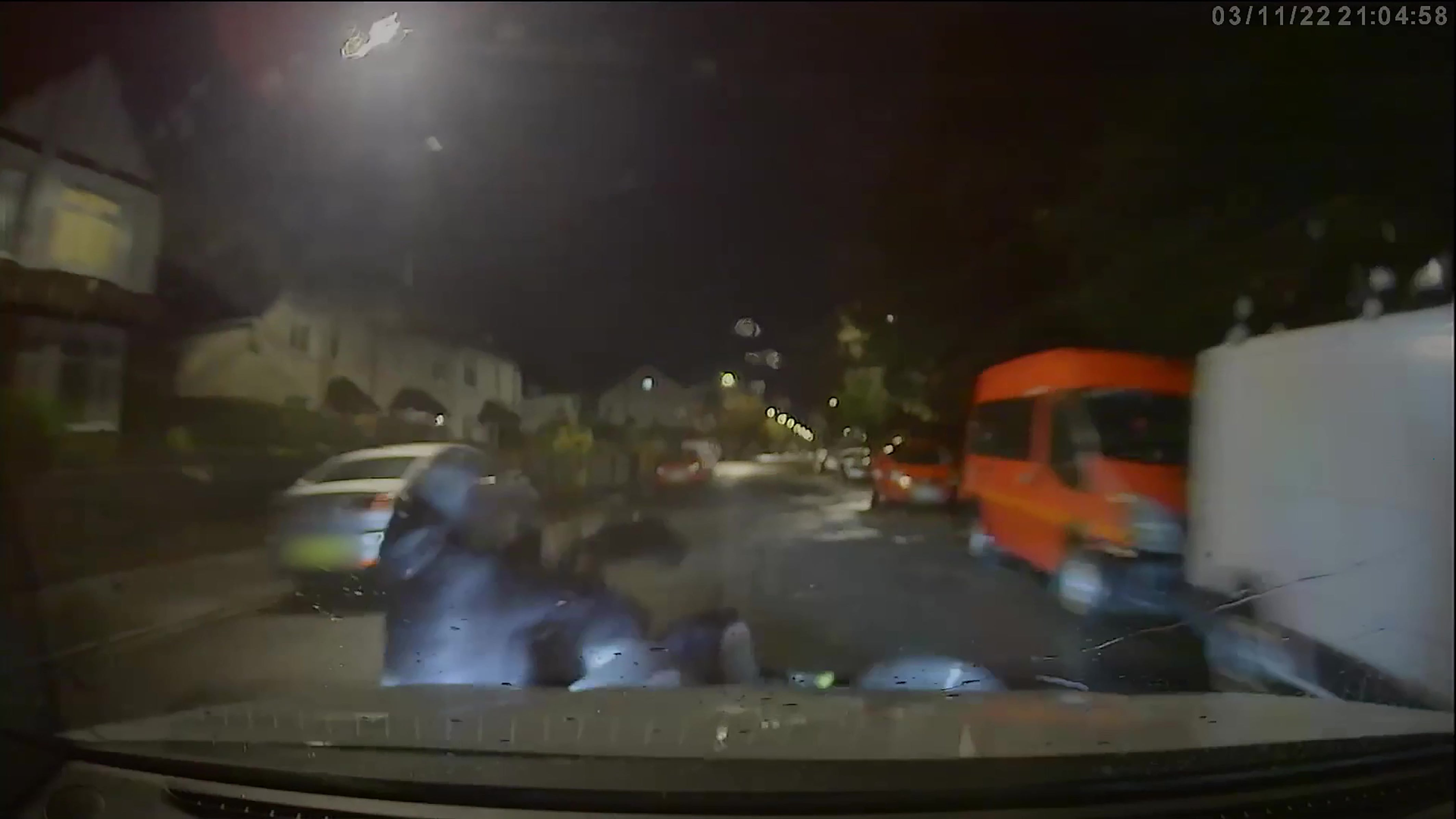 <p>Screen grab from handout video dated 03/11/22 which has been played to the jury showing the moment a marked police car driven by former Pc Tim Bradshaw knocks the rider and pillion passenger off an electric motorbike in Hawthorn Road, Bognor Regis</p>
