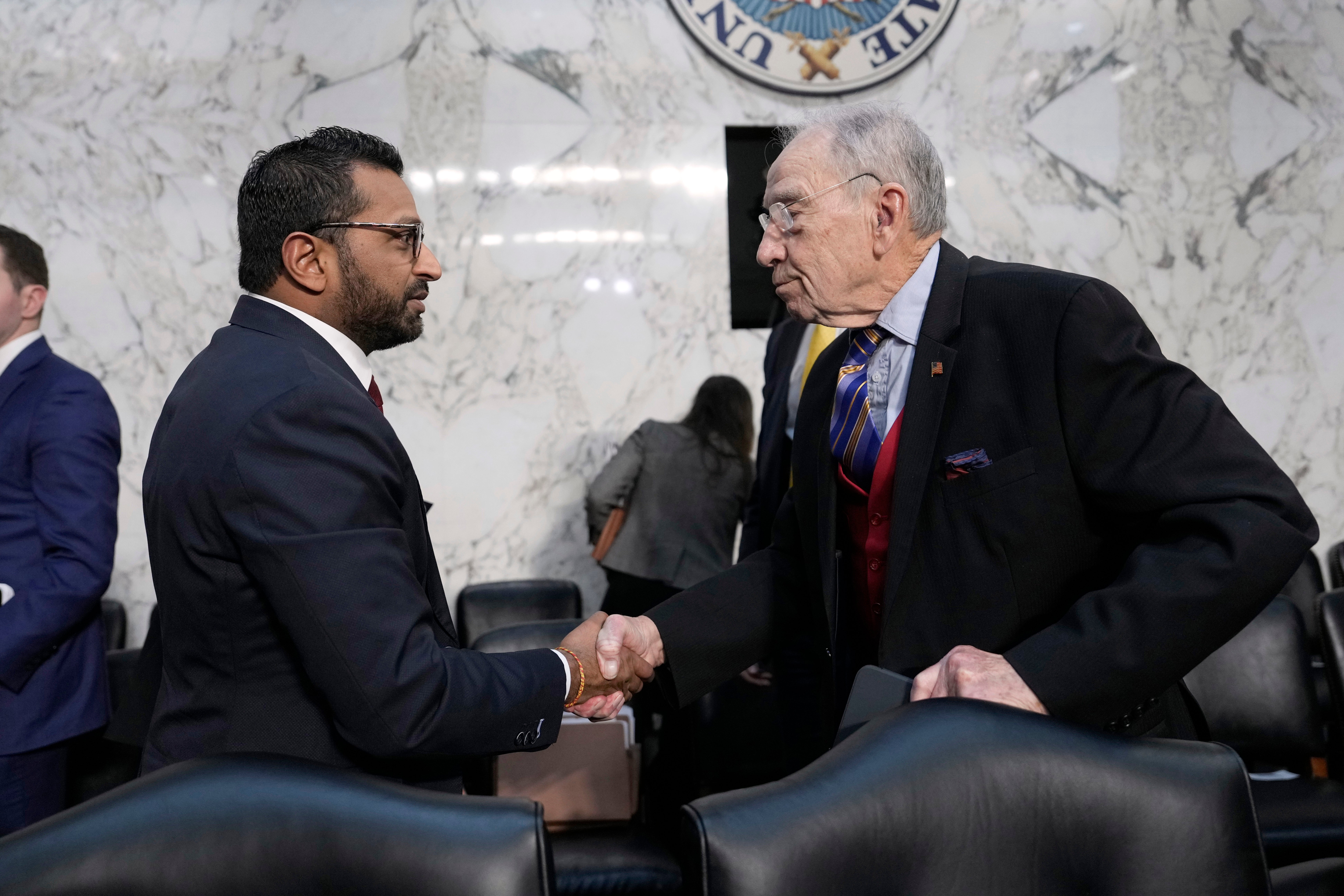 Kash Patel shakes the hand of Sen. Chuck Grassley (R-Iowa) as he departs following a confirmation hearing before the Senate Judiciary Committee at the Capitol in Washington last week. Patel was paid by a Russian filmmaker with ties to the Kremlin