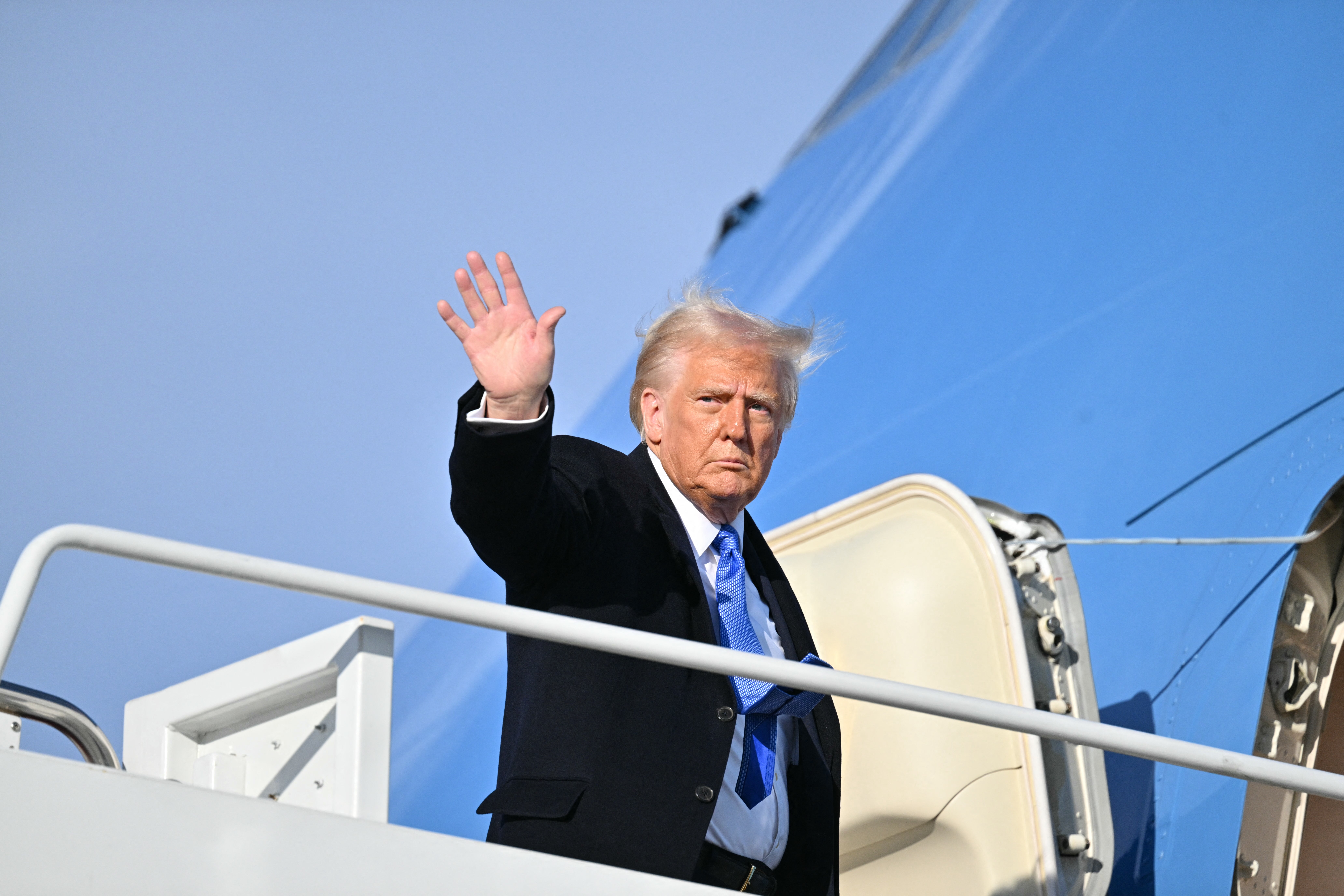 President Donald Trump waves as he boards Air Force One at Joint Base Andrews in Maryland.. Trump is traveling to his Mar-a-Lago resort in Palm Beach, Florida, before heading to the Super Bowl in New Orleans on Sunday.