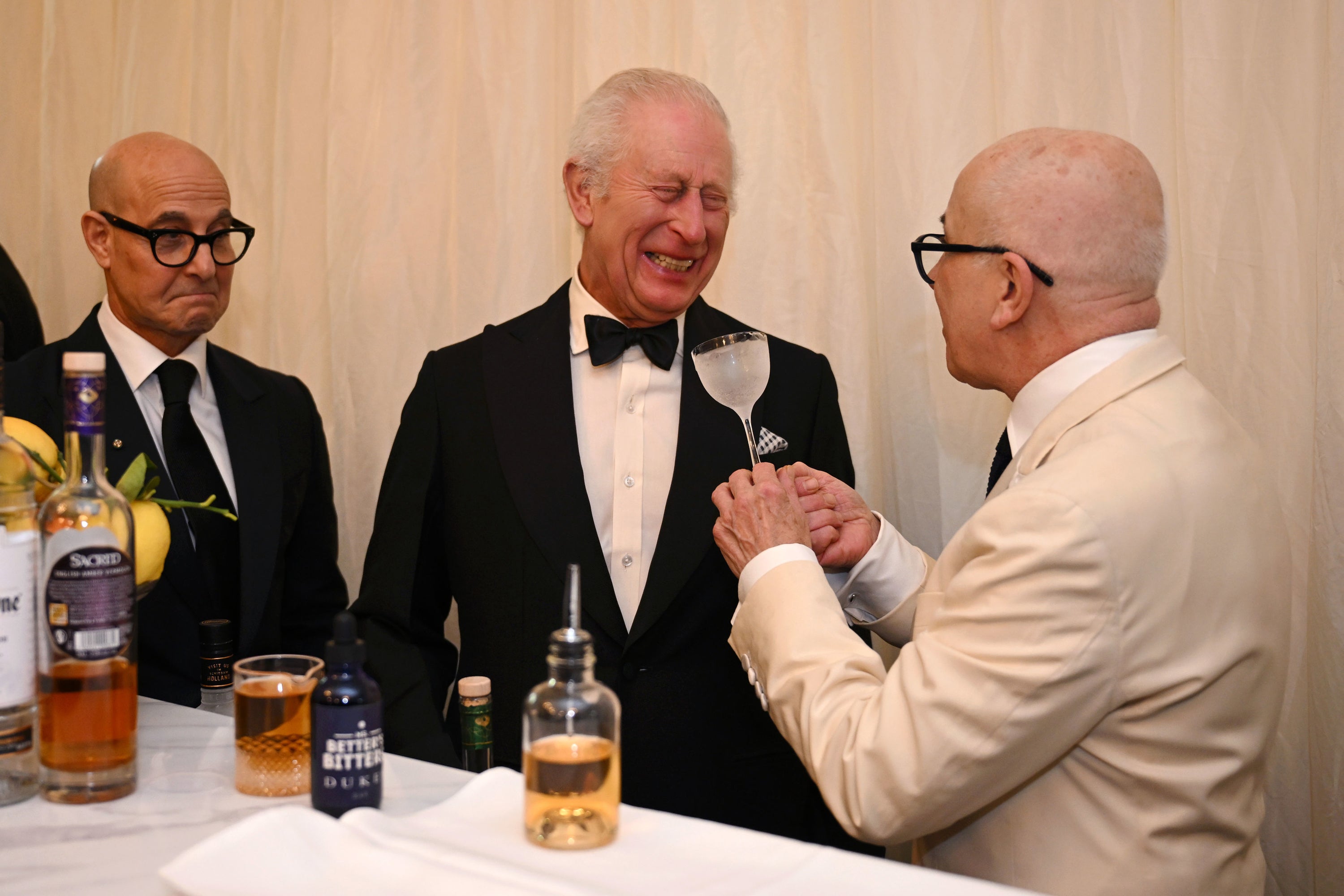 Hollywood star Stanley Tucci (left) watches as King Charles III and Italian mixologist, Alessandro Palazzi, mix a drink