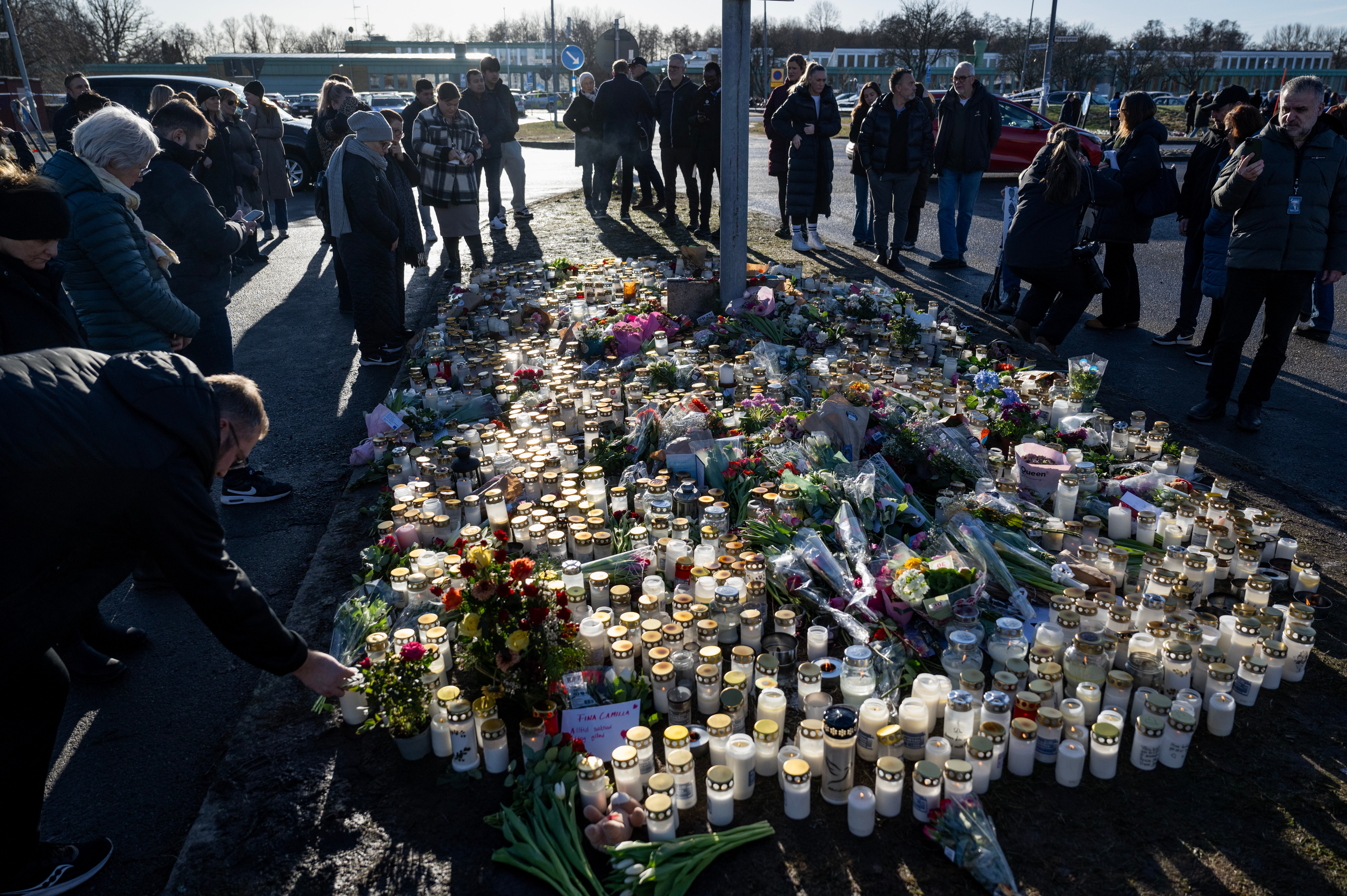 Mourners leave flowers and candles at the memorial site outside the school after the shooting in Risbergska school in Orebro