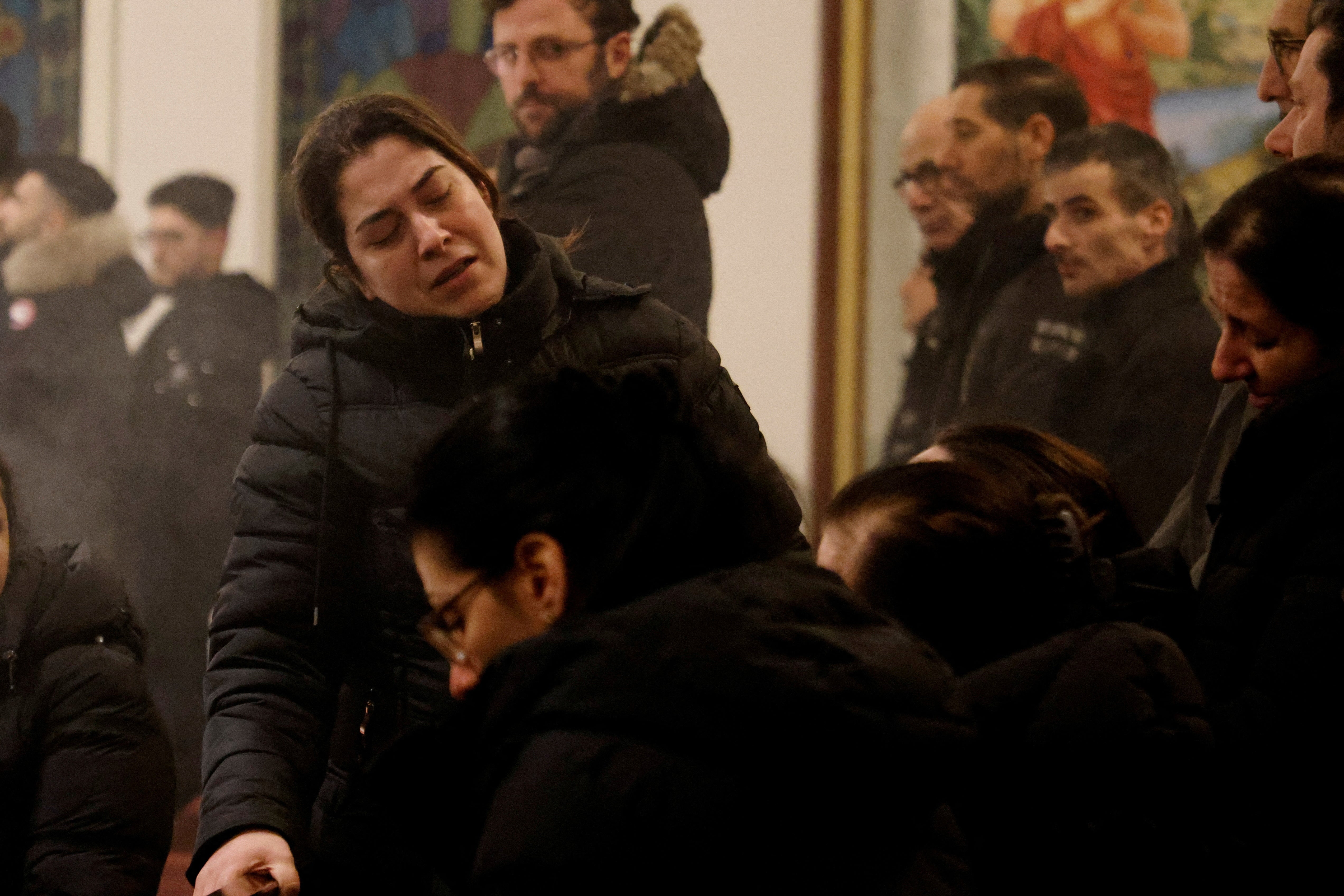 Family members of mass shooting victim Salim Iskef mourn at St. Mary's Church in Orebro, Sweden