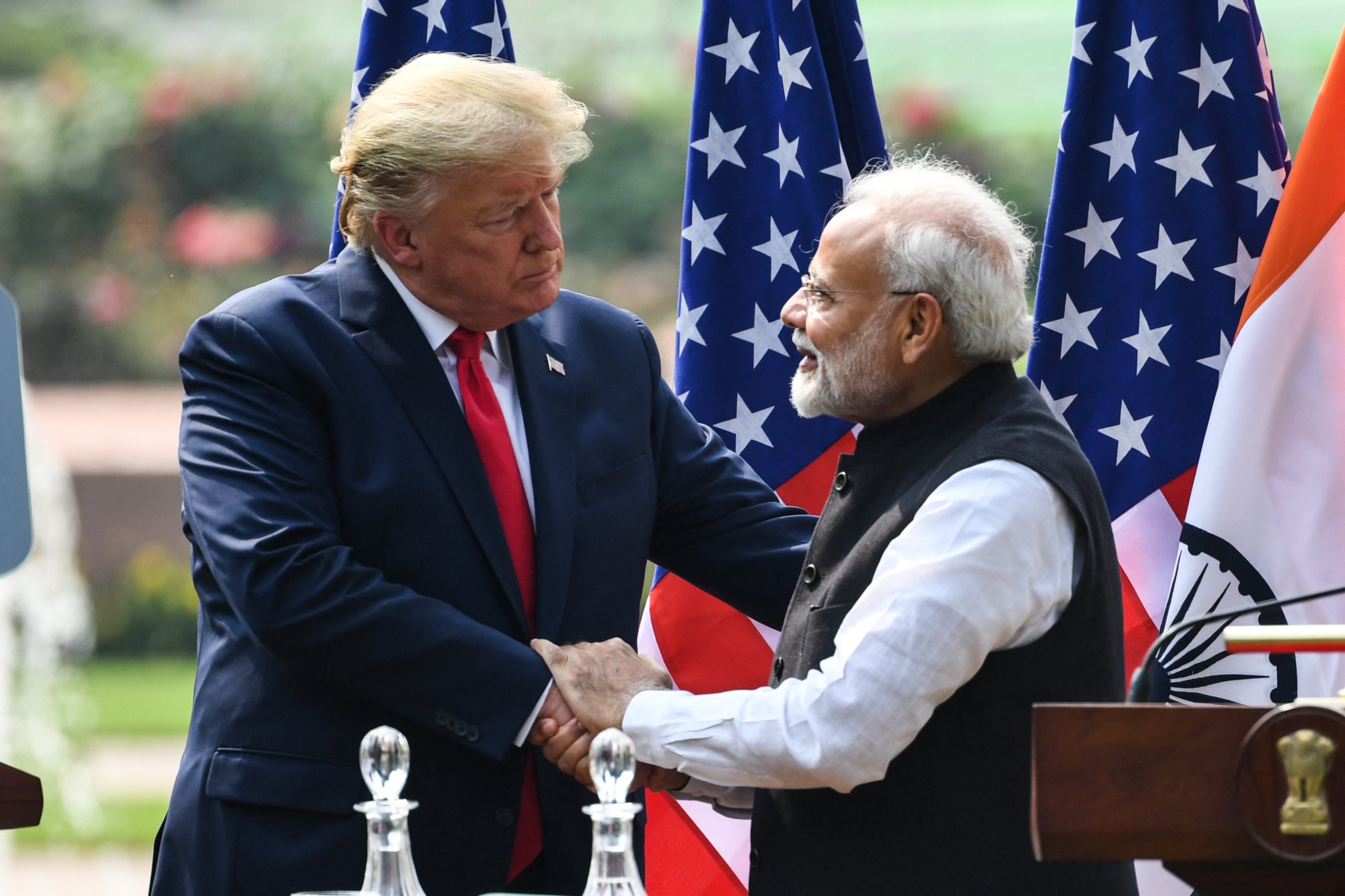 US President Donald Trump (L) shakes hands with India's Prime Minister Narendra Modi during a joint press conference at Hyderabad House