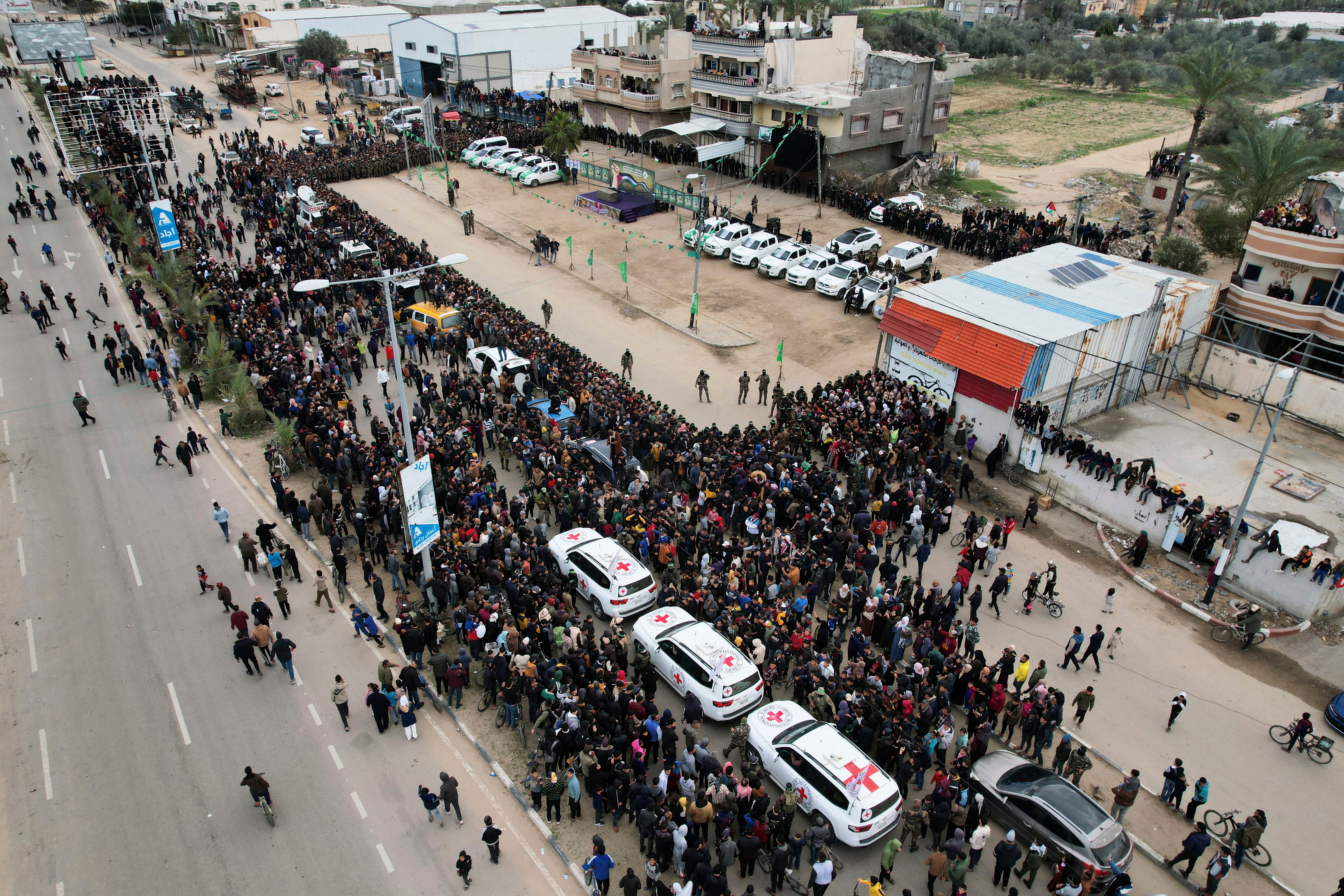 International red cross cars wait for Israeli captives, Ohad Ben Ami, Eli Sharabi and Or Levy, who have been held hostage by Hamas in Gaza since October 7, 2023, in Deir al-Balah, central Gaza Strip.