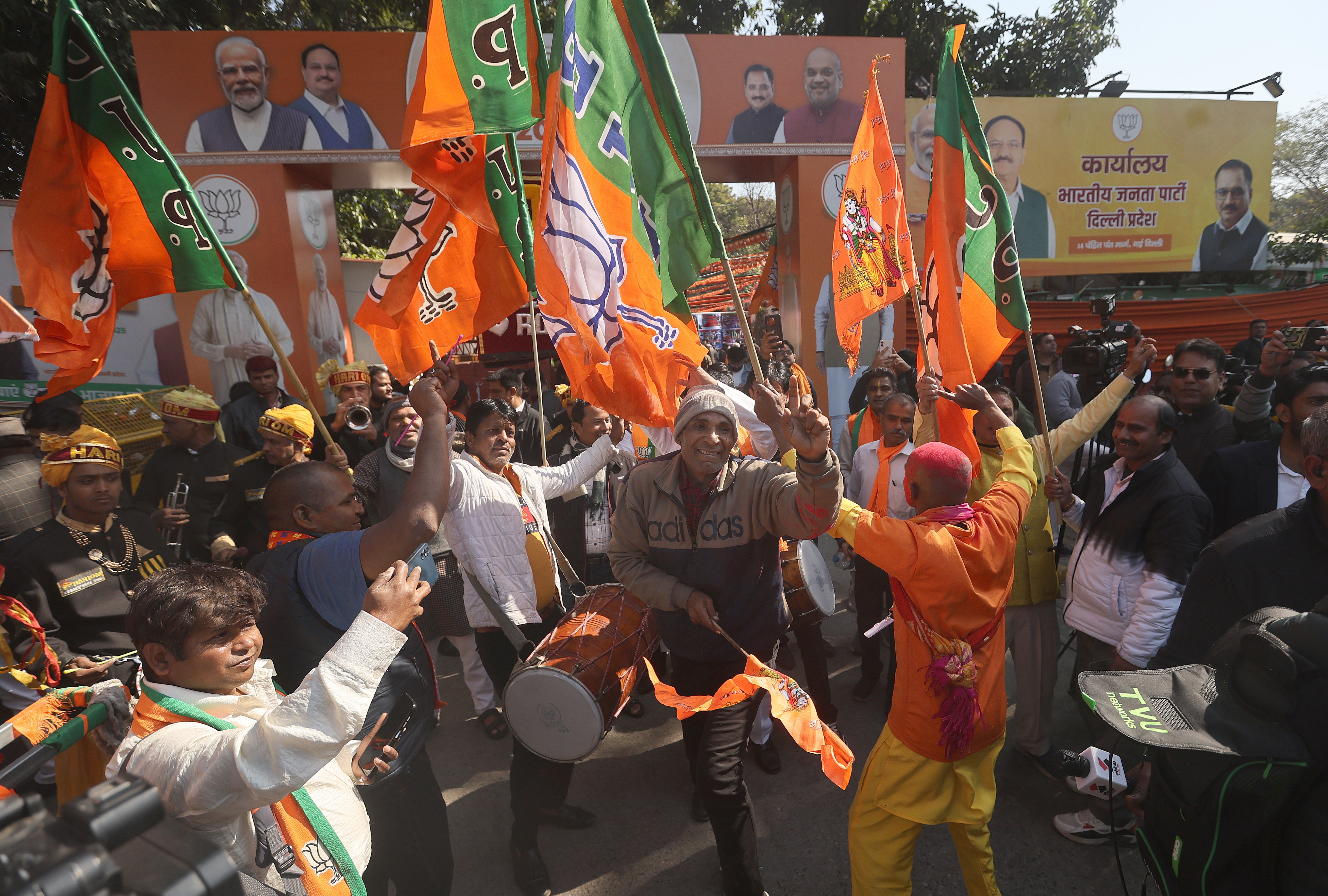 Bharatiya Janata Party (BJP) party workers celebrate the party's lead in votes for the Delhi Assembly elections, at the party headquarters