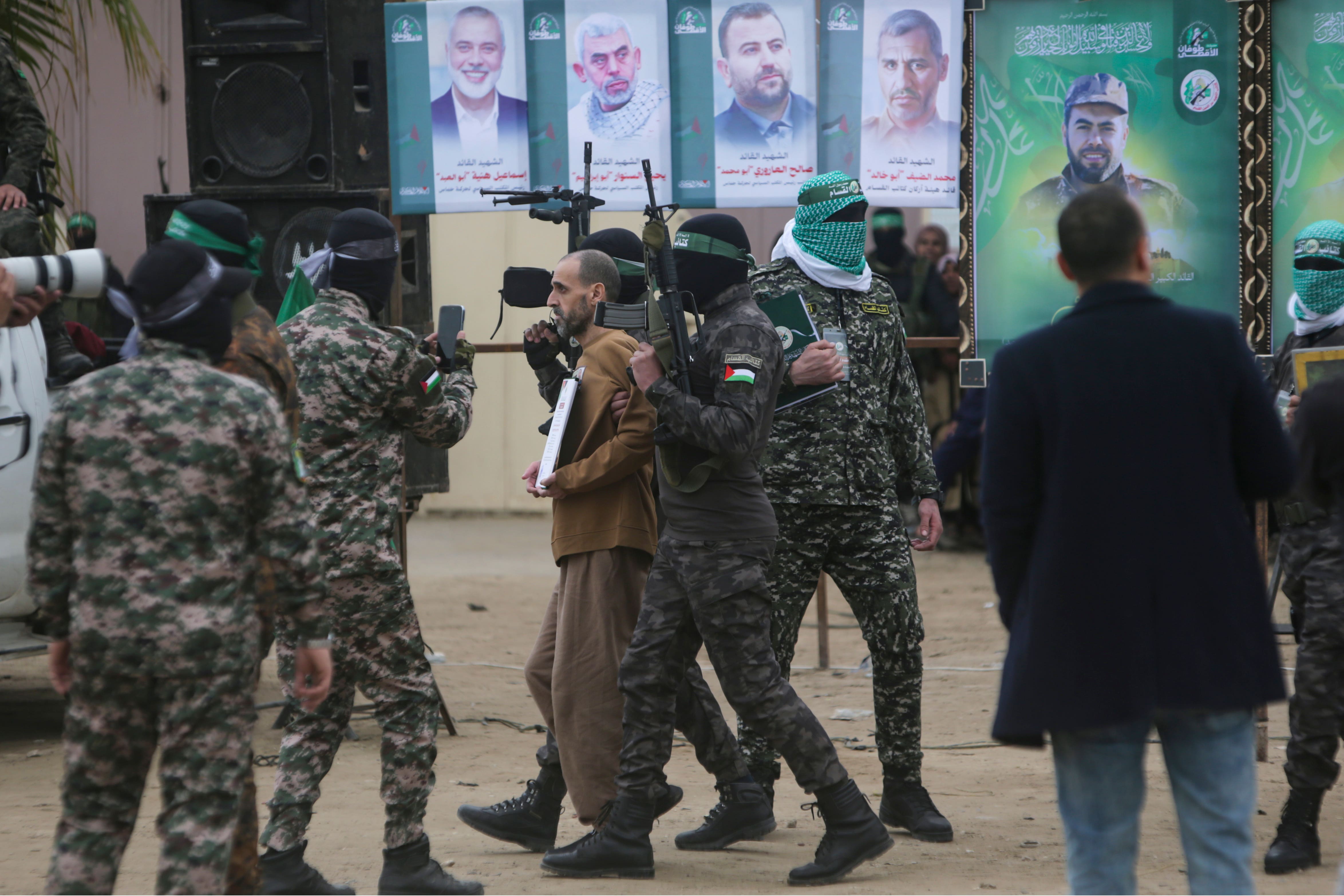 Eli Sharabi is escorted by Hamas fighters before being handed over to the Red Cross (Jehad Alshrafi/AP)