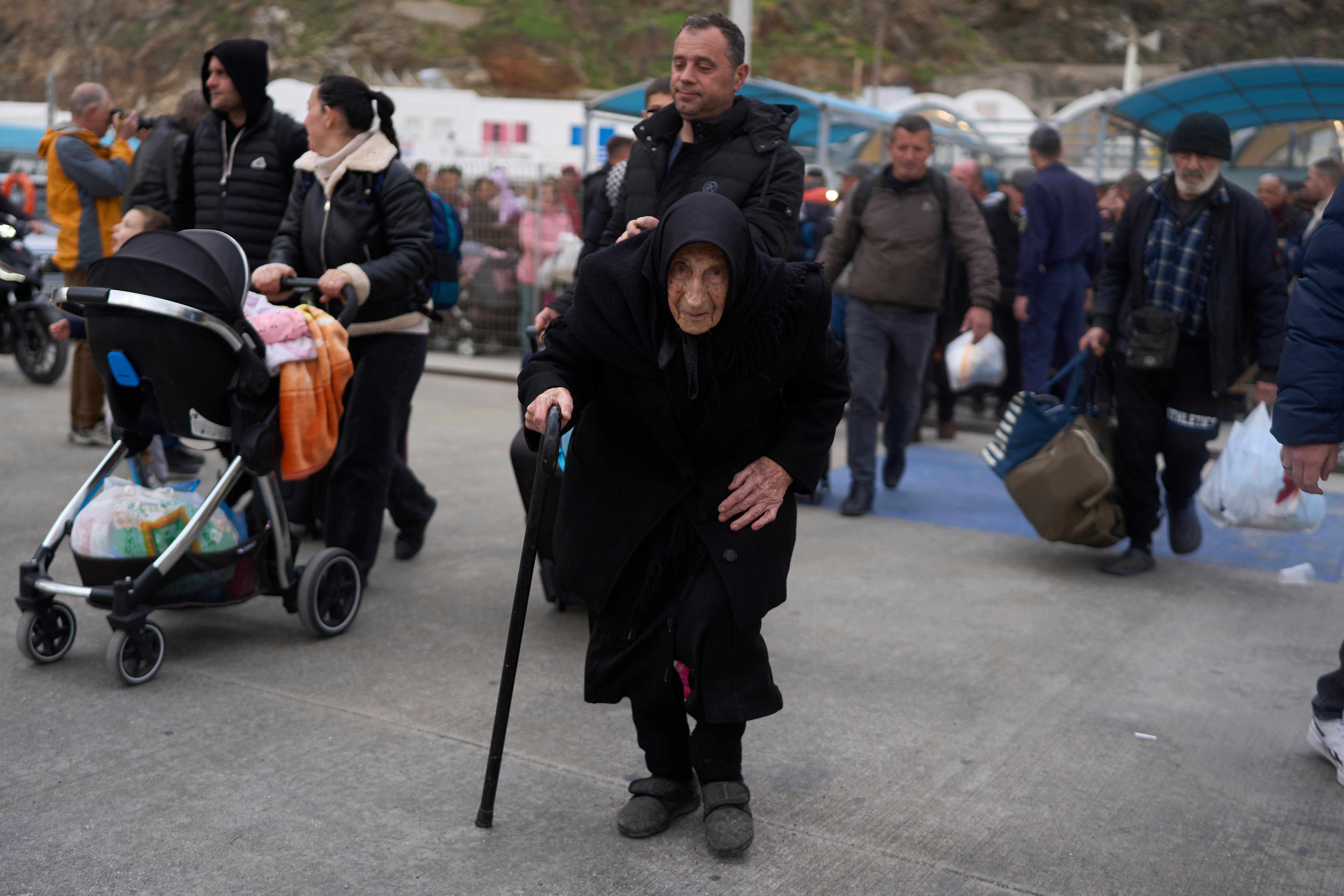 Flora Karamolegou, 94, prepares to leave Santorini