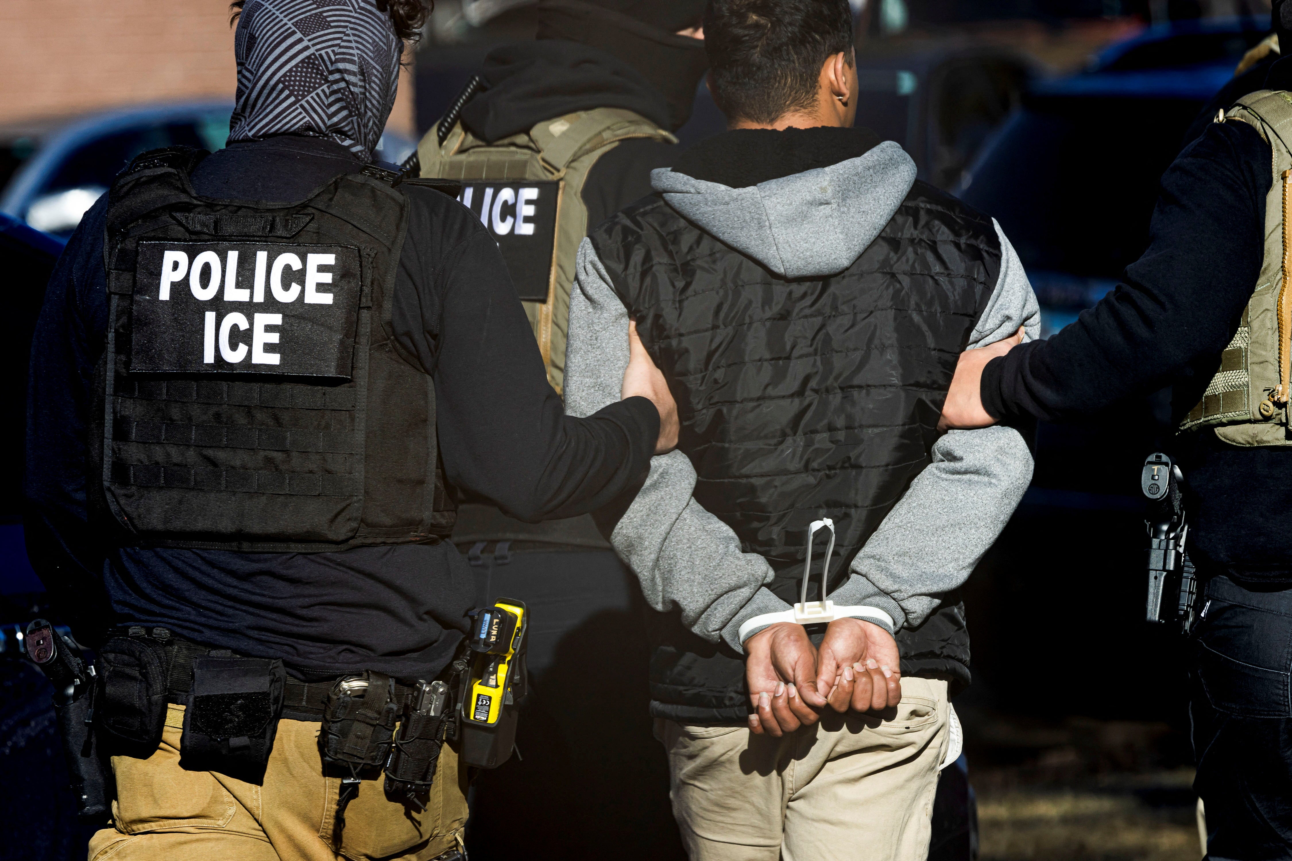 ICE agents detain a man in Denver, Colorado. The Trump administration is reportedly considering using Defense Department funding to ramp up their deportation efforts