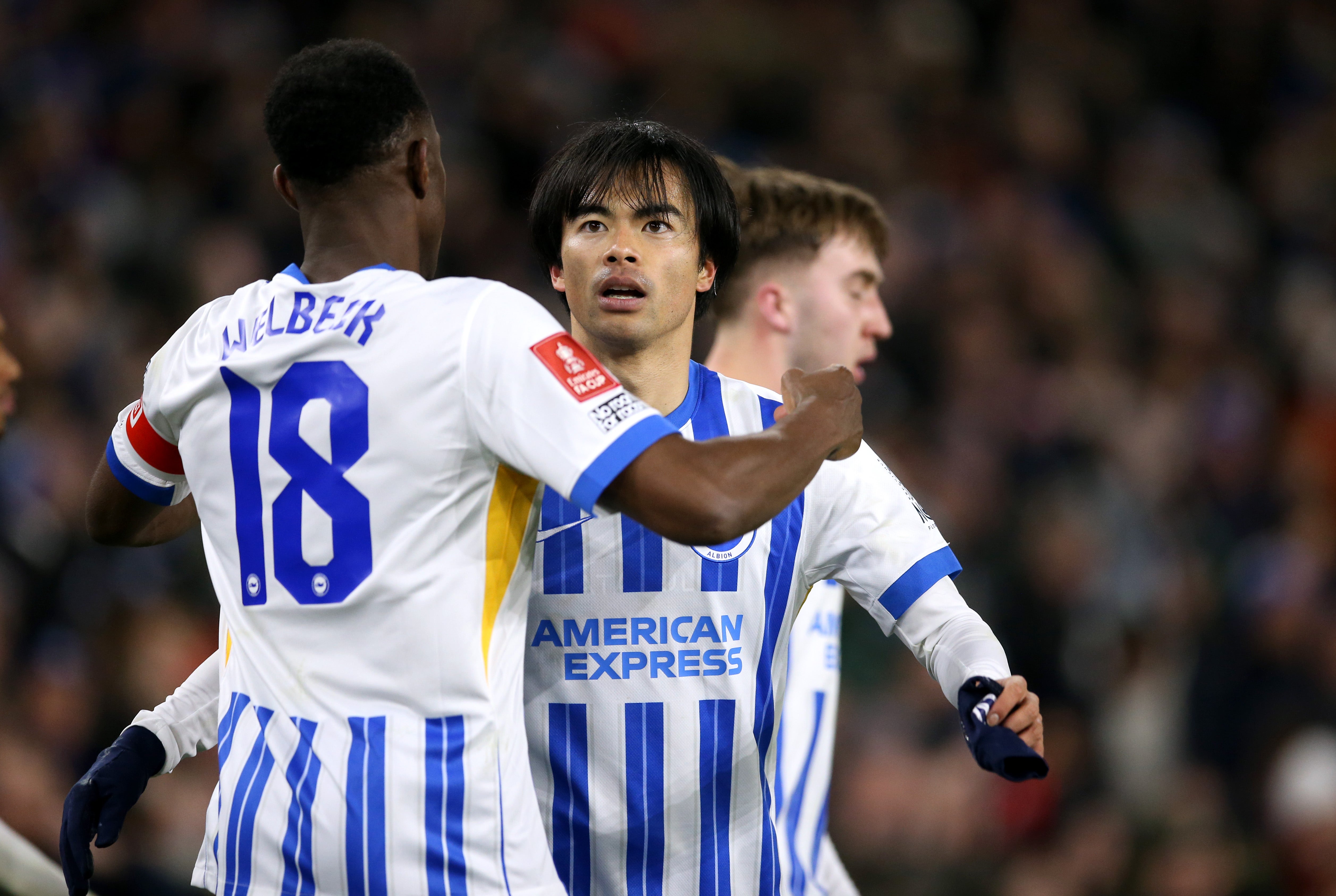 Danny Welbeck congratulates Brighton teammate Kaoru Mitoma on netting against Chelsea