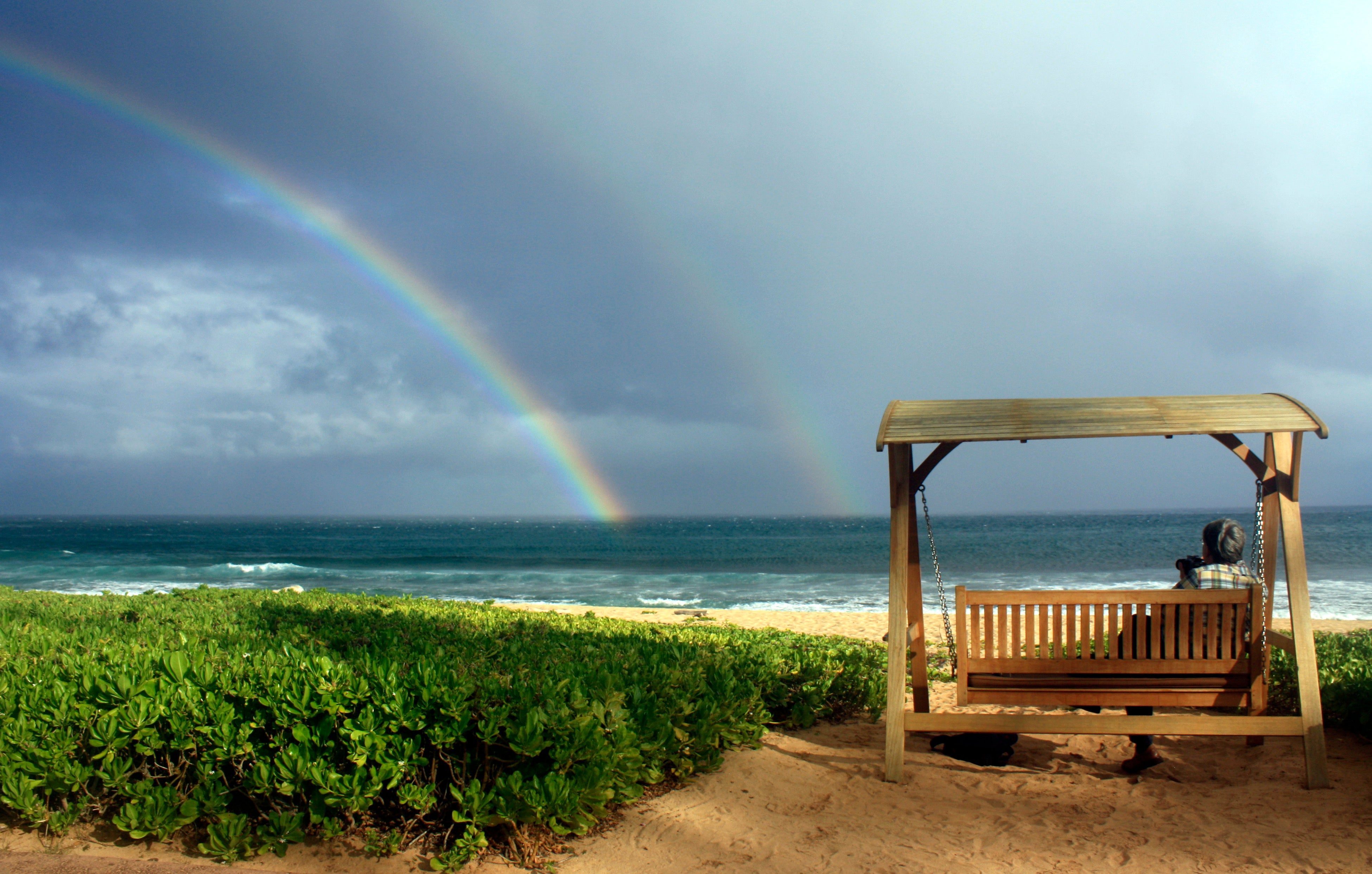 Joseph Heher photographs rainbows at Shipwreck’s Beach, Grand Hyatt Kauai, Hawaii