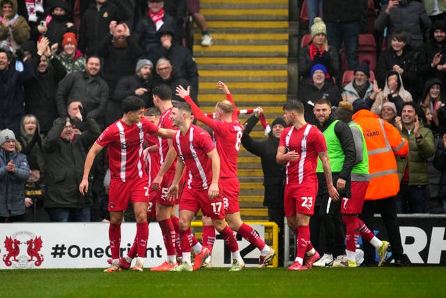 Jamie Donley, centre, celebrates after Leyton Orient went 1-0 up against Manchester City (Kin Cheung/AP)