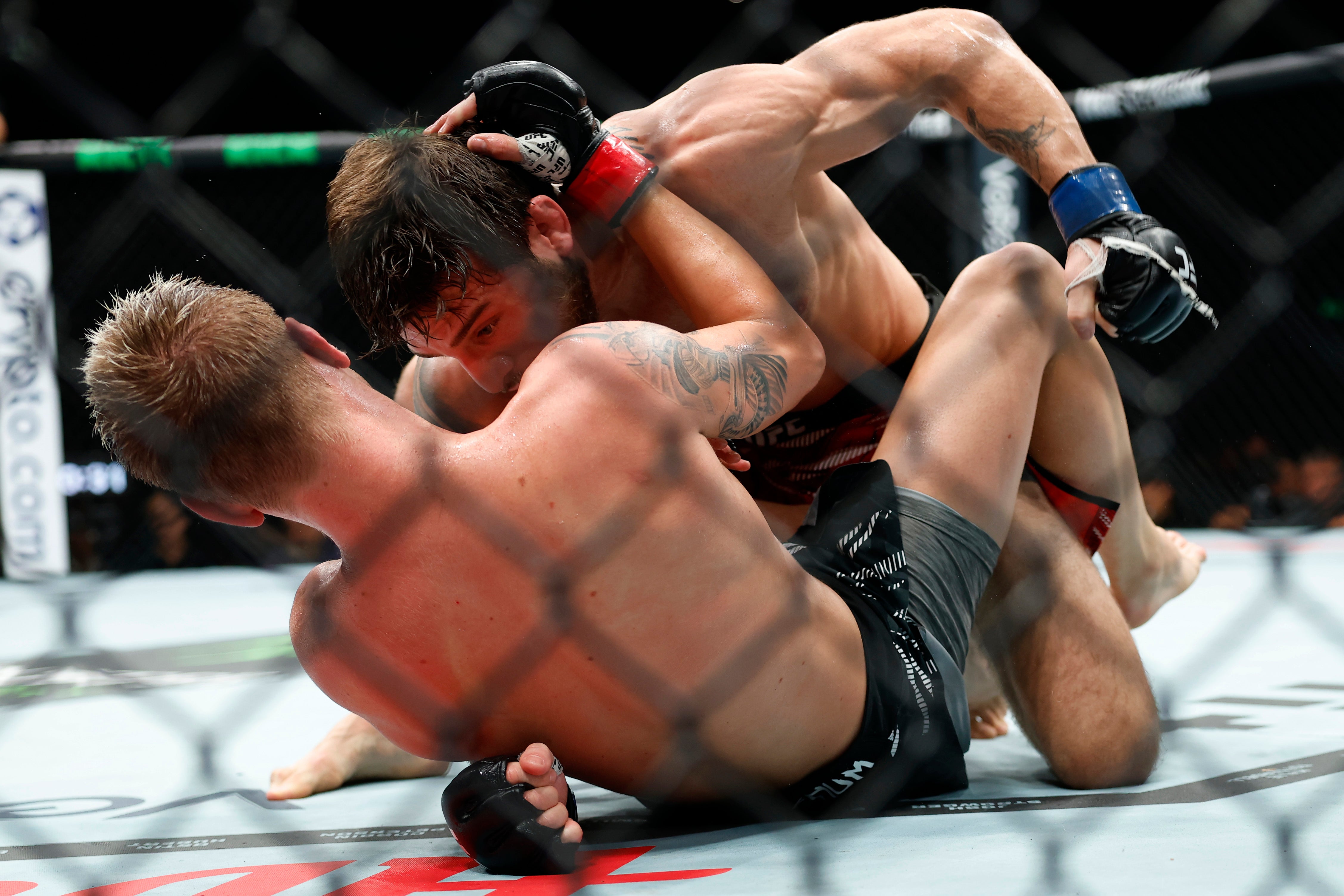 Aleksandre Topuria controls and strikes Colby Thicknesse