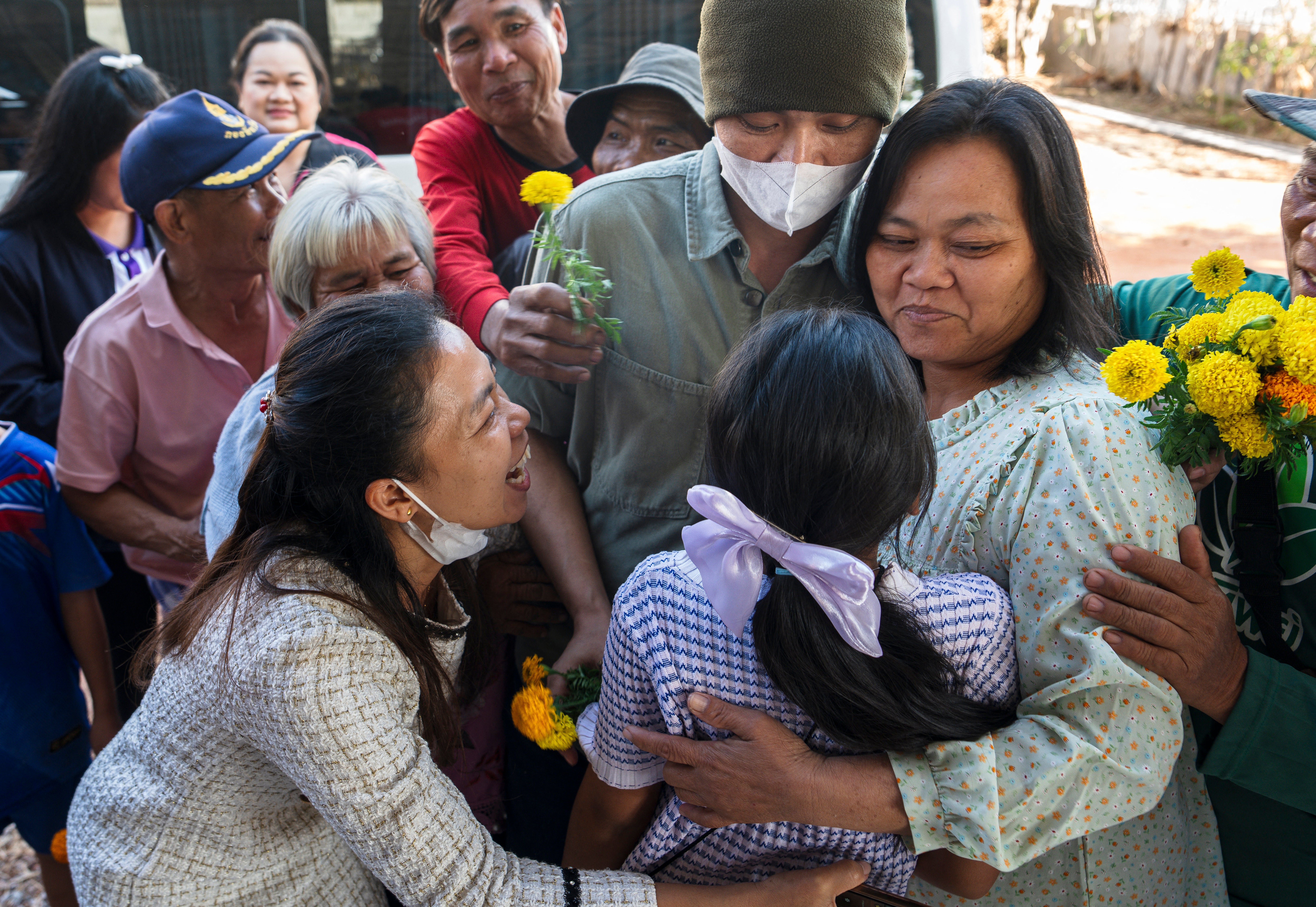 Freed Thai farm worker Watchara Sriaoun hugs his mother