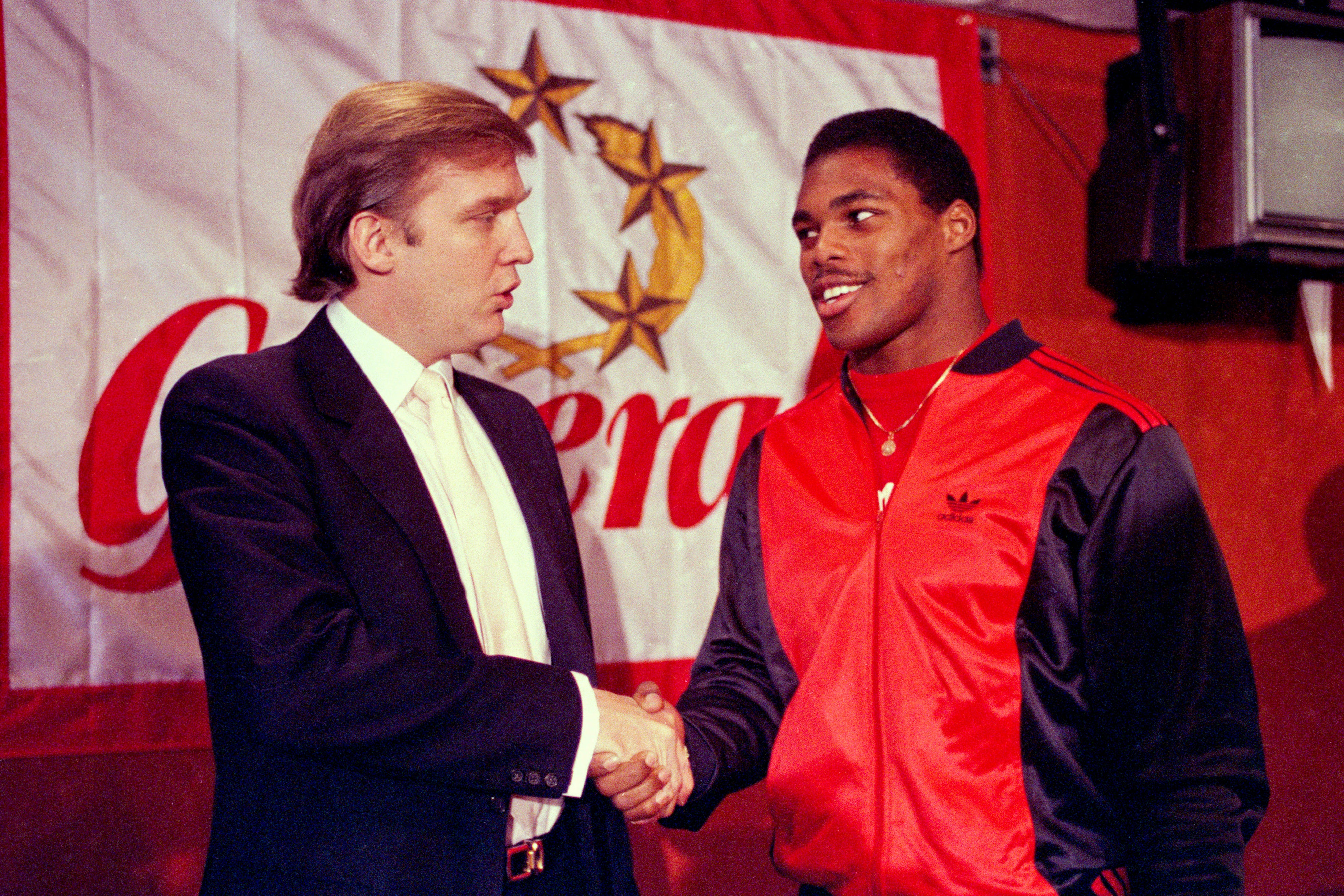 Trump, then owner of the New Jersey Generals USFL team, shakes hands with new signing (and future politcal candidate) Herschel Walker in March 1984