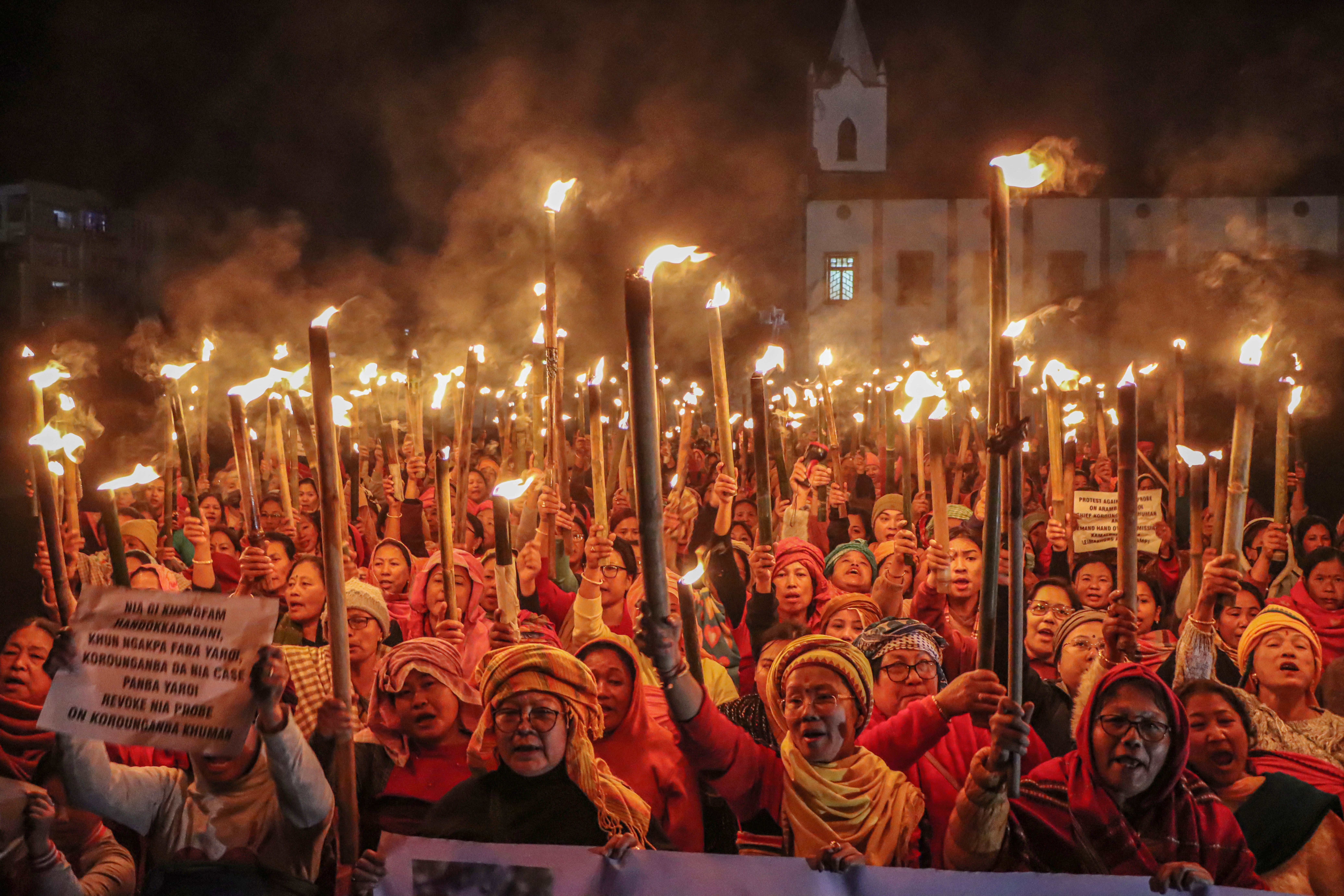 <p>File. Members of a women's group hold torches during a protest rally demanding justice for a missing Meitei man in Manipur state</p>