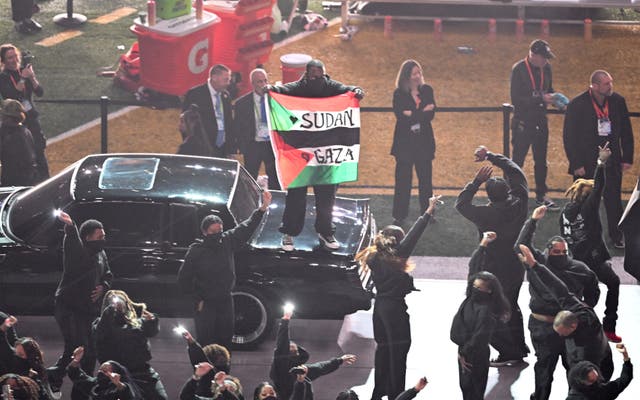 <p>A protester unfurled a pro-Palestine flag onstage during Kendrick Lamar’s Super Bowl set on Sunday</p>