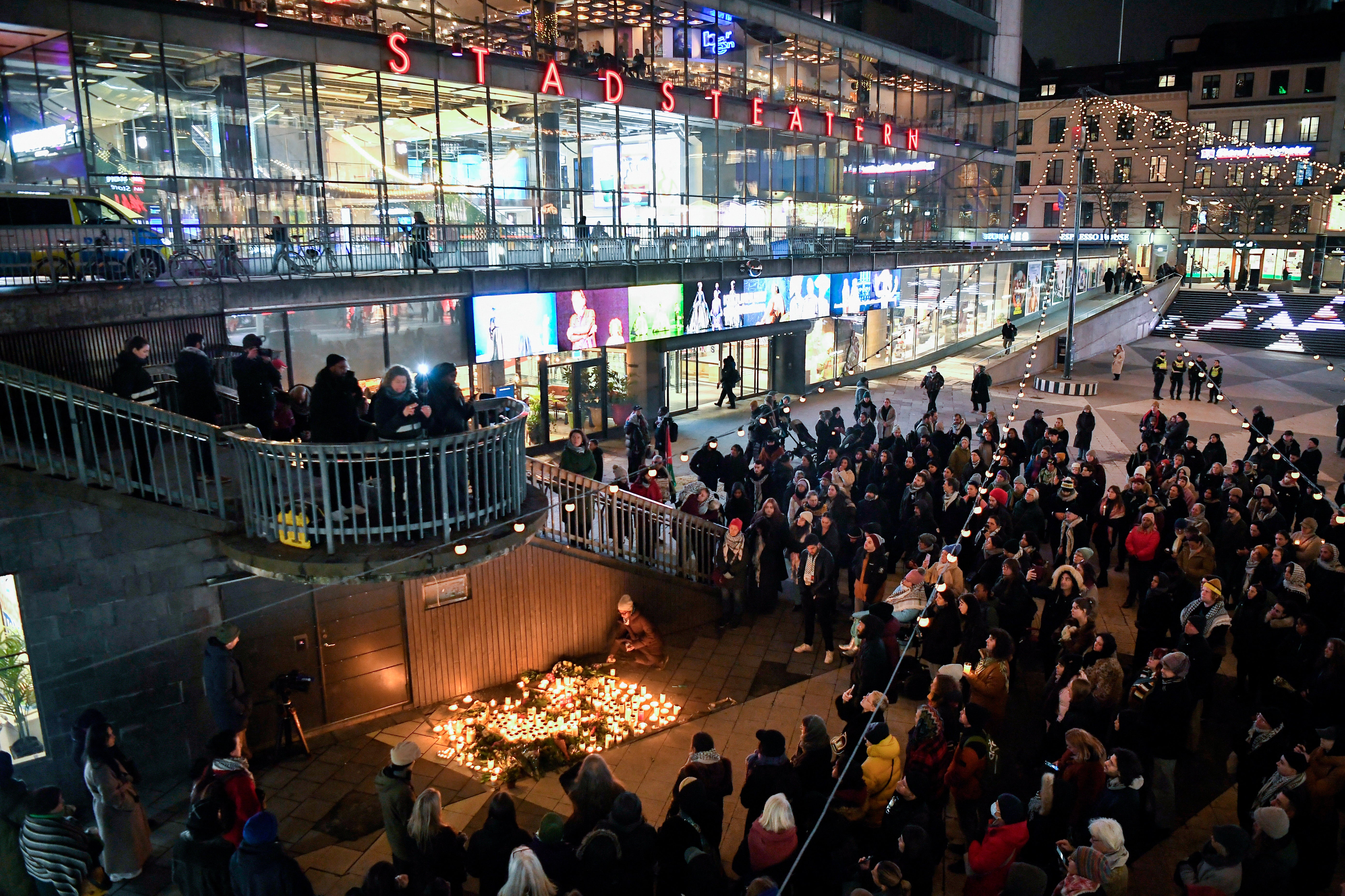 People gather at Sergels square to honor the victims of the shooting at the adult education center Campus Risbergska school in Orebro