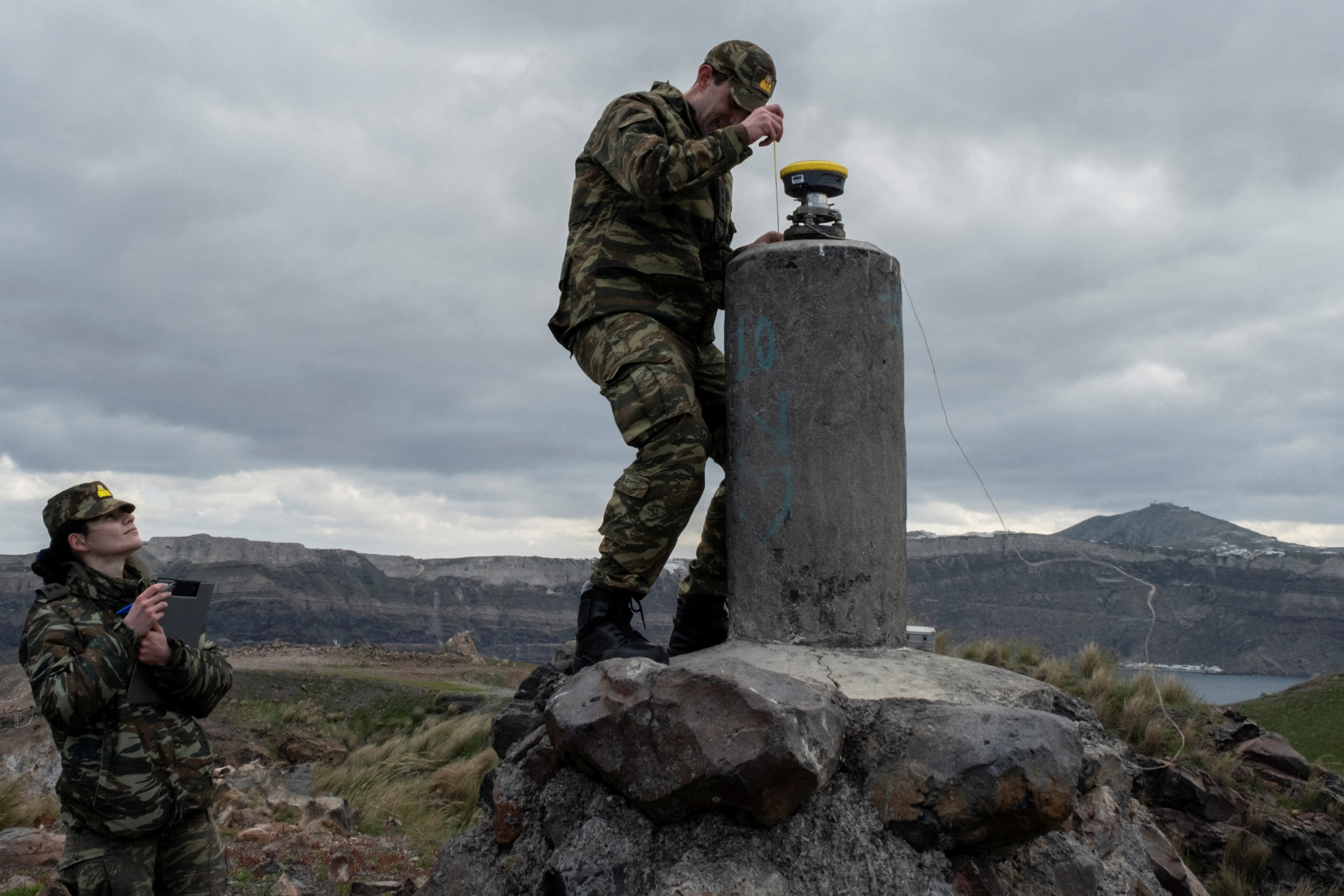 The Greek military take measurements on Santorini's neighbouring volcanic island of Nea Kameni on Monday