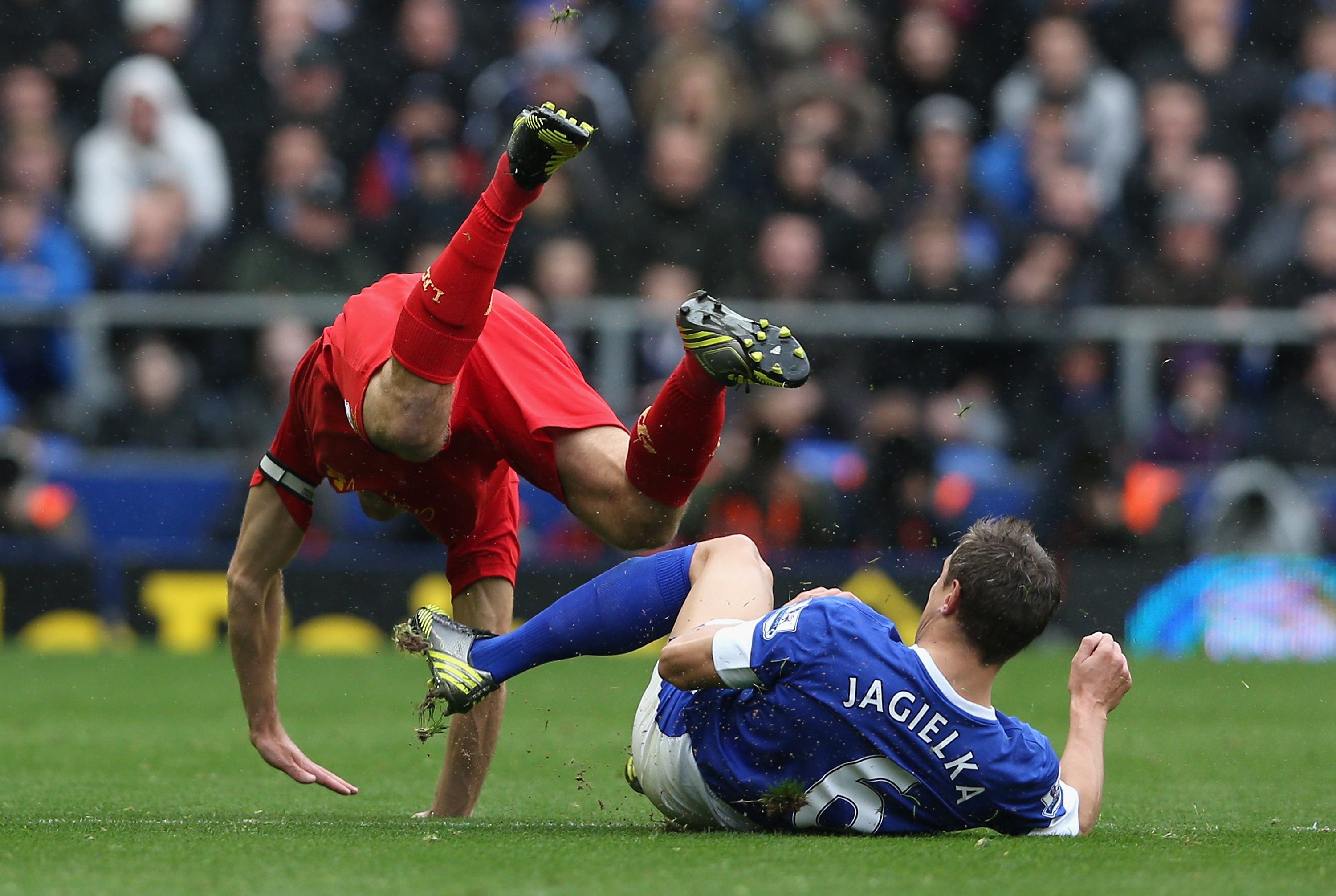 Steven Gerrard of Liverpool is brought down by Phil Jagielka of Everton in 2012