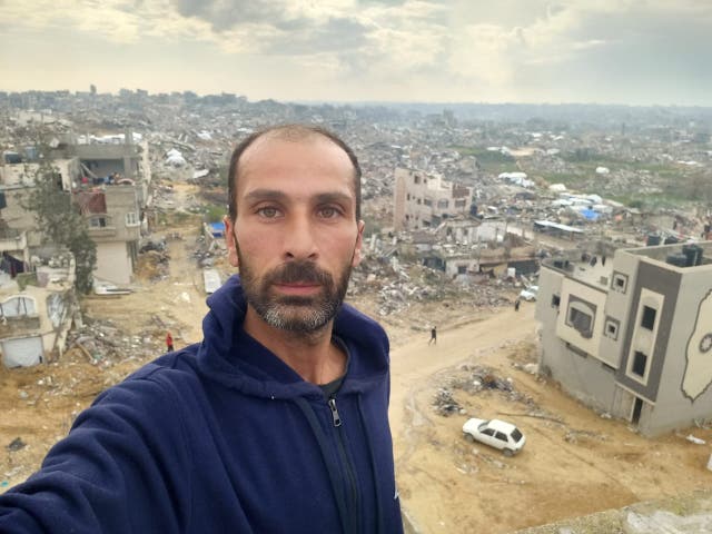 <p>Nedal Hamdouna, a Palestinian journalist, returns to his destroyed family home in north Gaza</p>